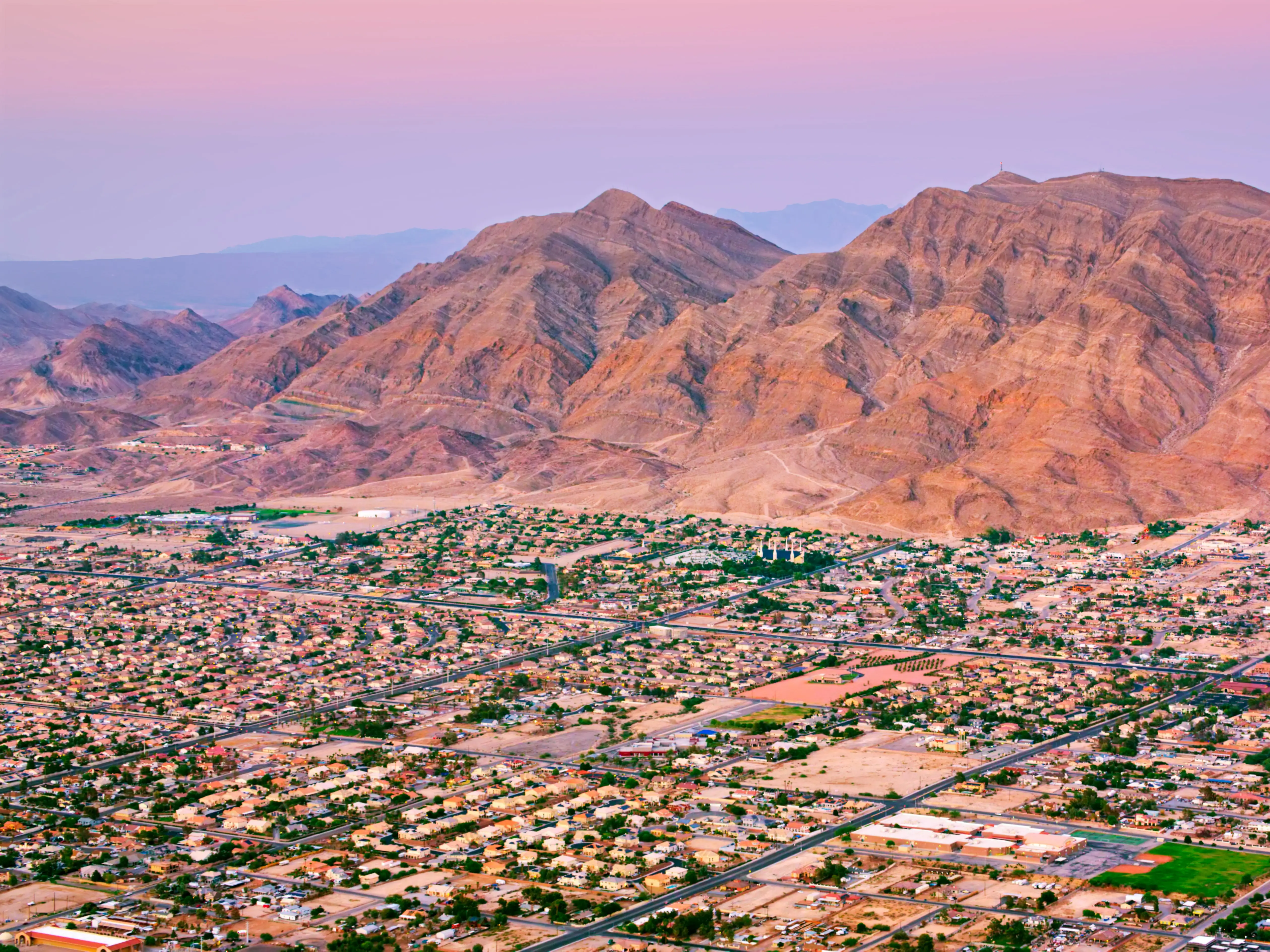 Aerial view of neighborhood in Las Vegas beneath Frenchman Mountain, Nevada