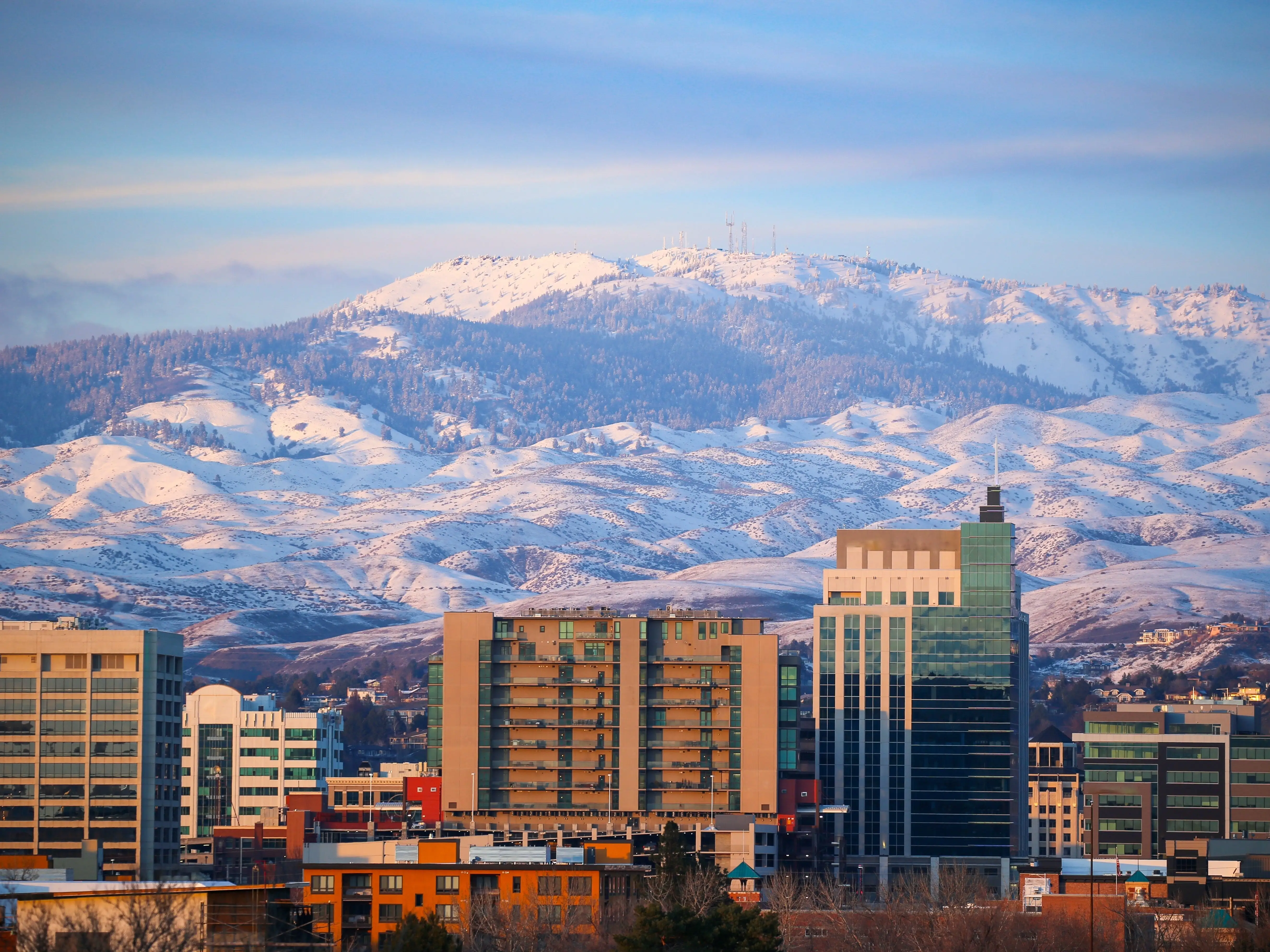 Skyline of downtown Boise, Idaho, with Bogus Basin Ski Resort in the background.