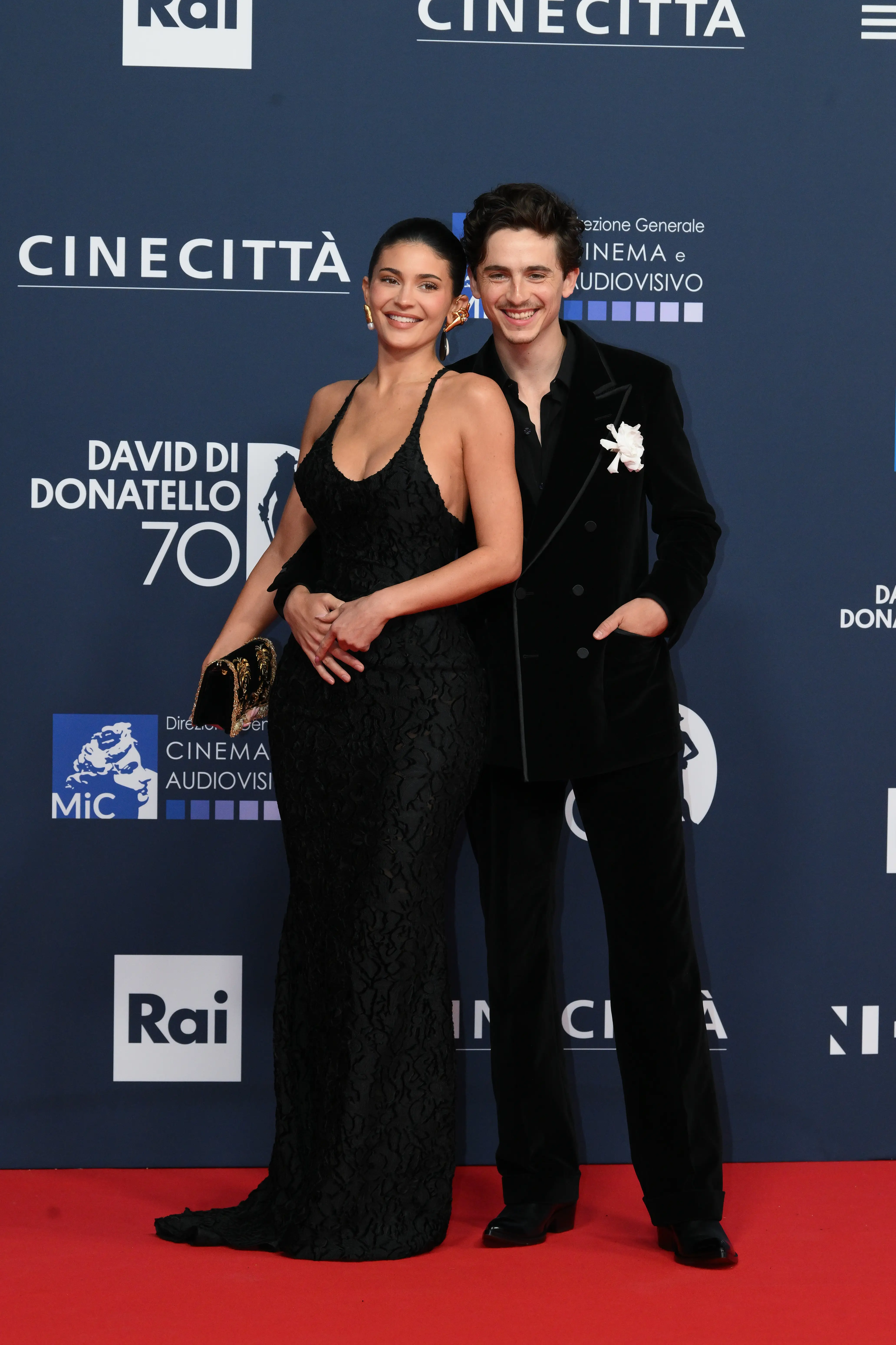 Kylie Jenner and Timothée Chalamet embrace on a red carpet.