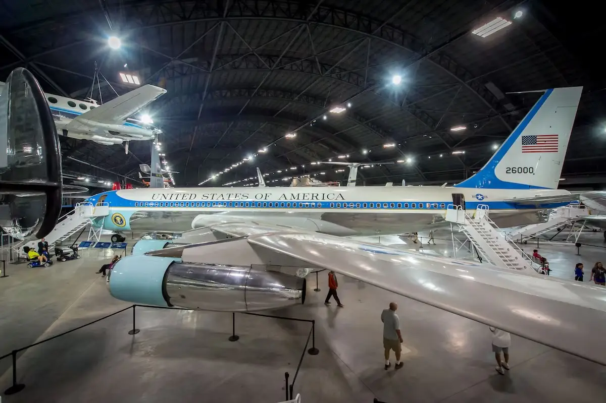 A blue and white plane on display in a museum, with 