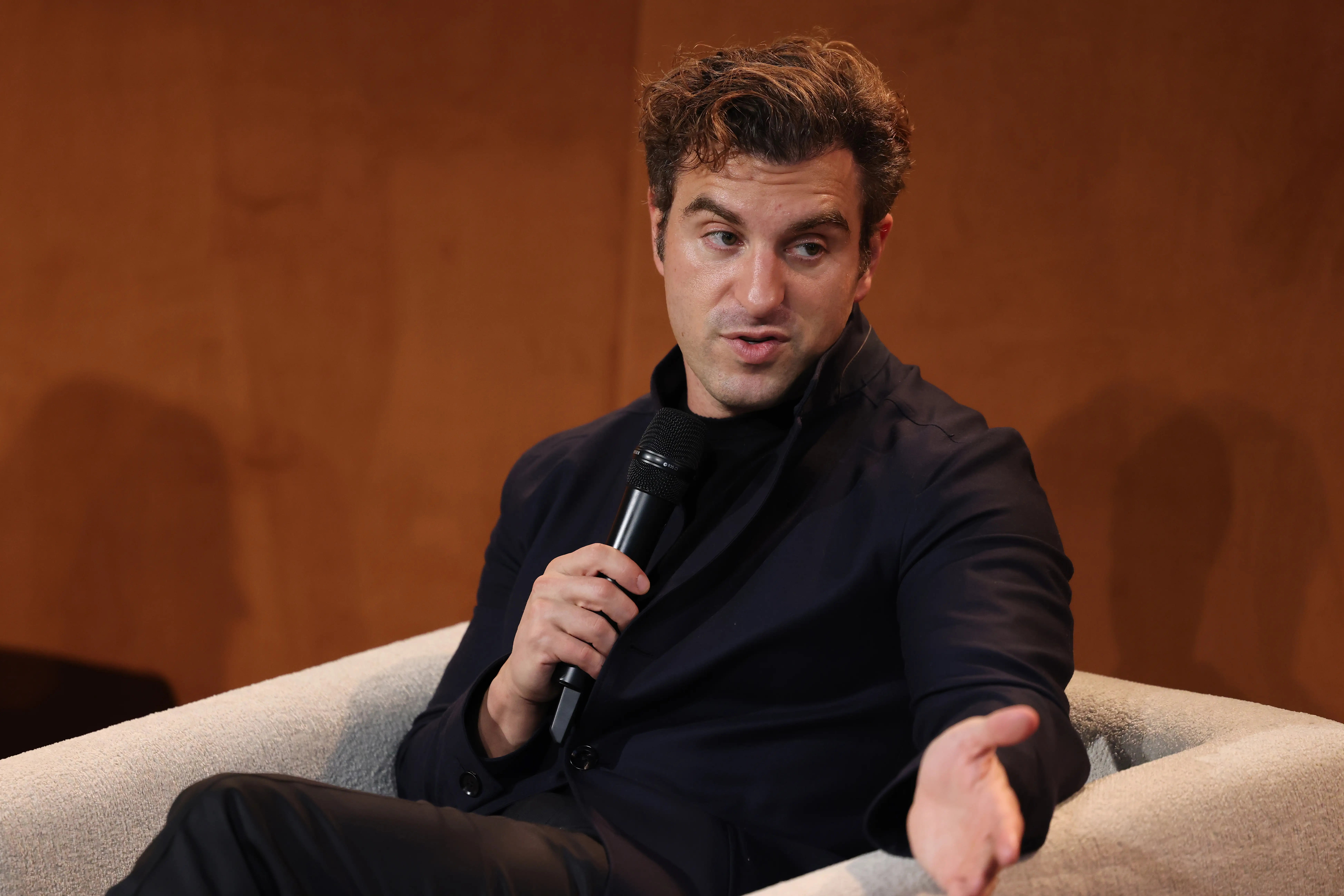 Brian Chesky speaking into a mic