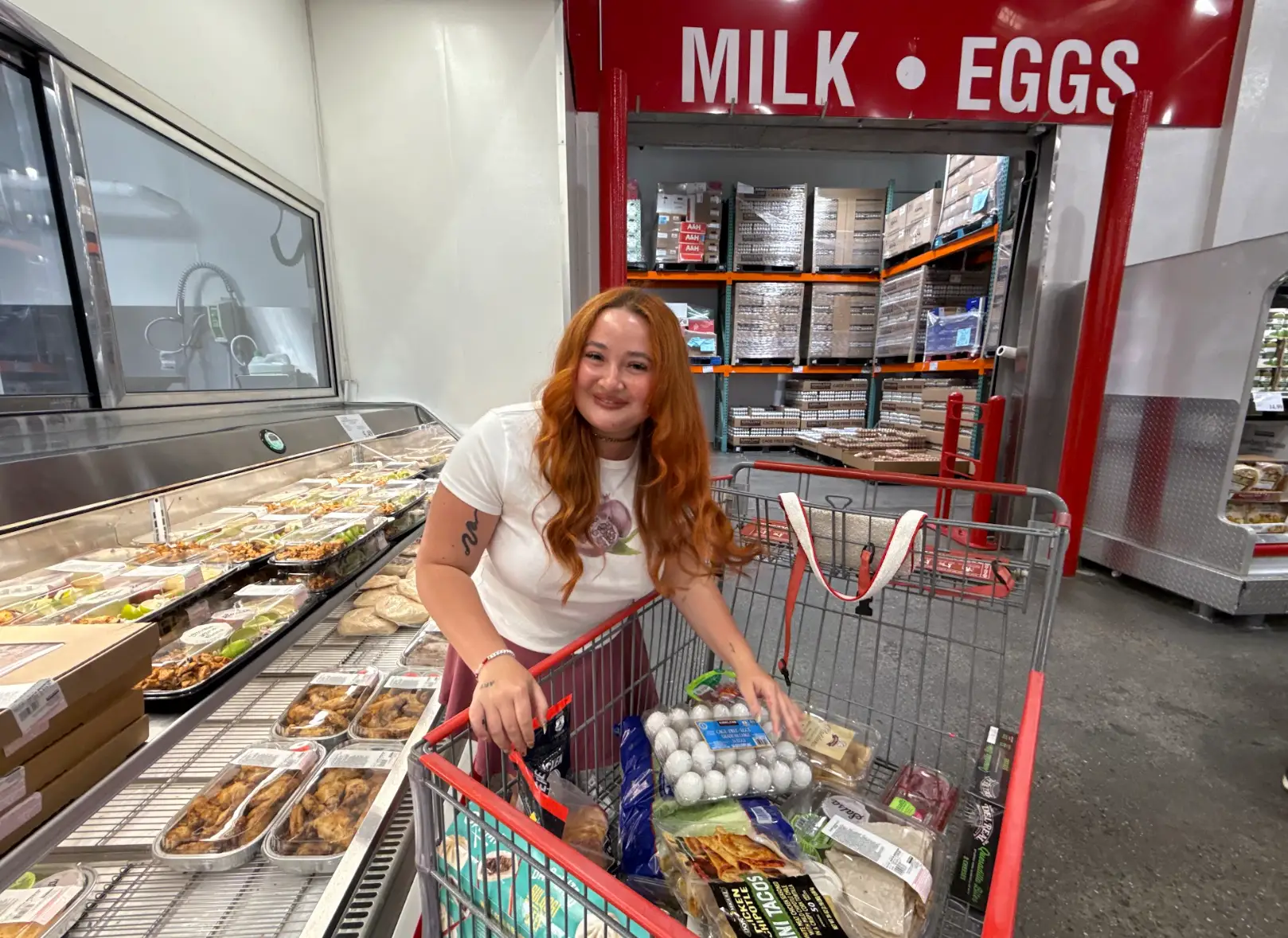 The writer with her cart of groceries at Costco.