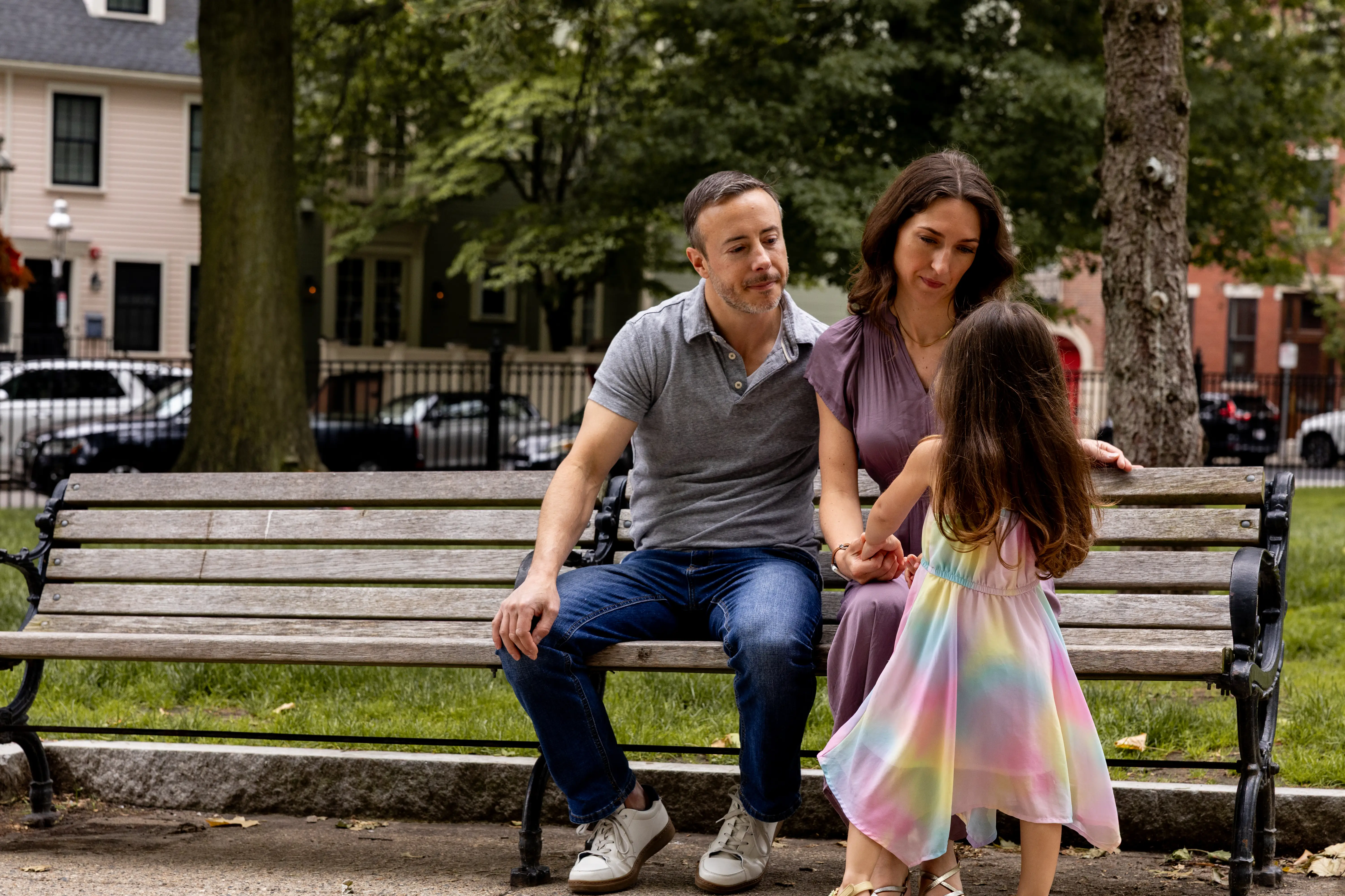 a family of three on a park bench