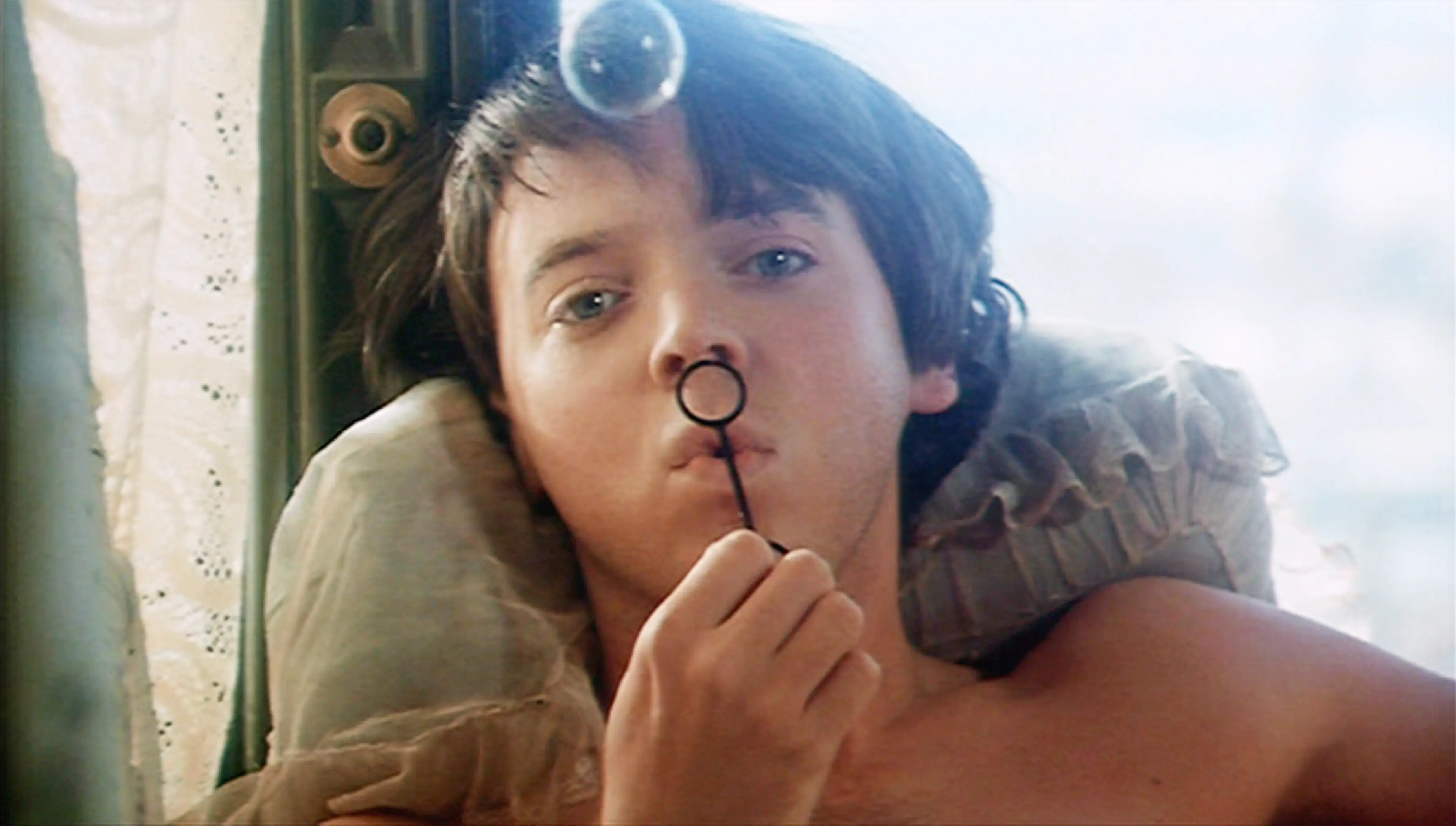 Bud Cort blowing a bubble