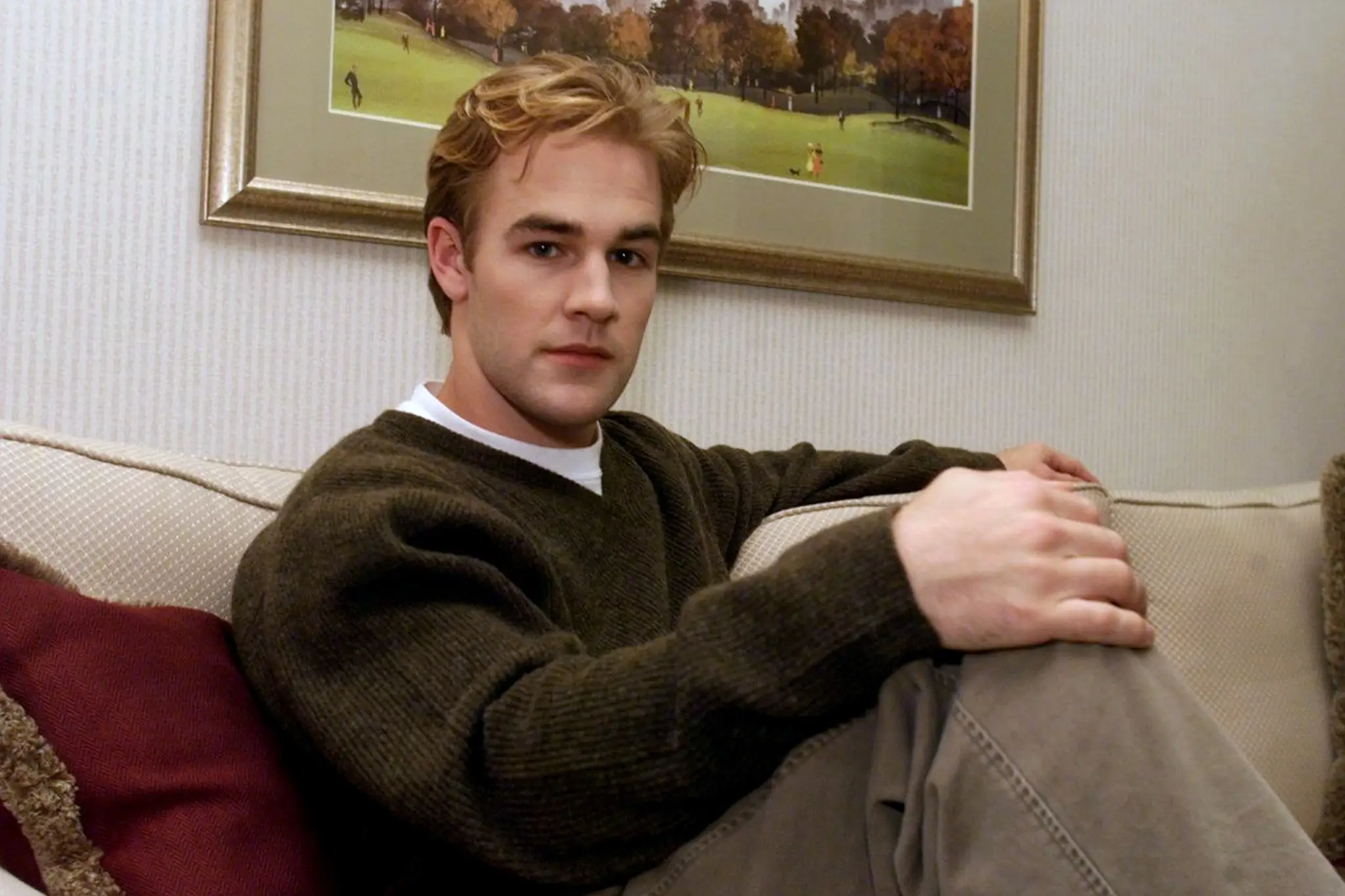 James Van Der Beek sitting on a couch