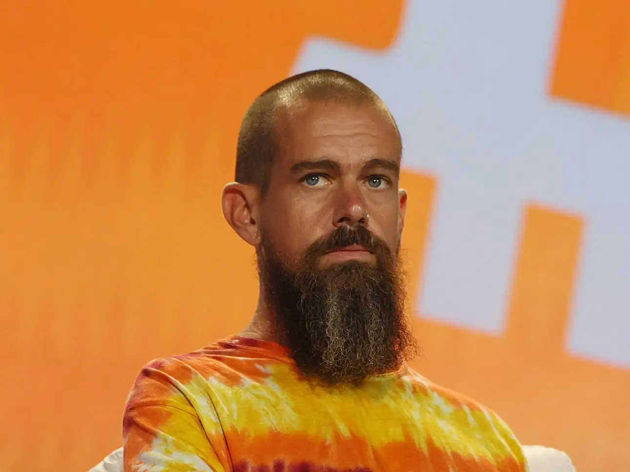 Jack Dorsey headshot orange background
