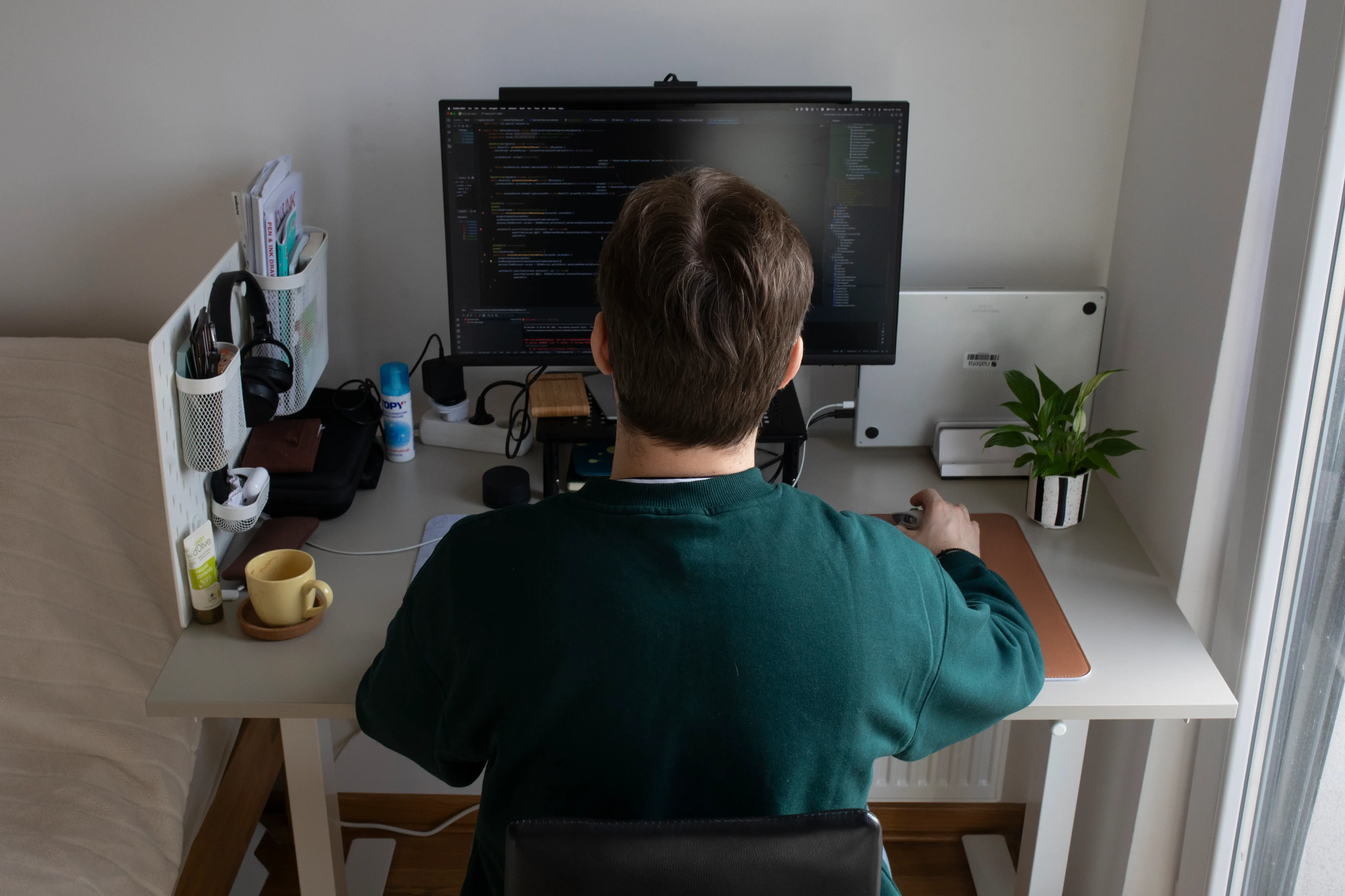 A man sitting at a desk working on a computer.