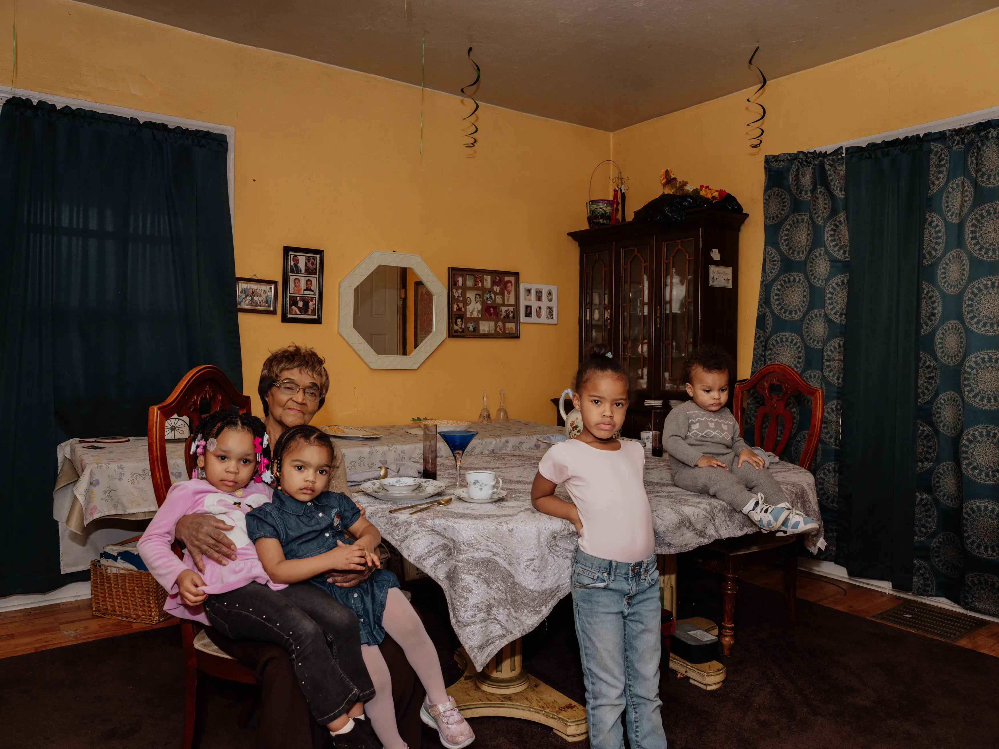 June Boyd and family sitting at the table in the dining room