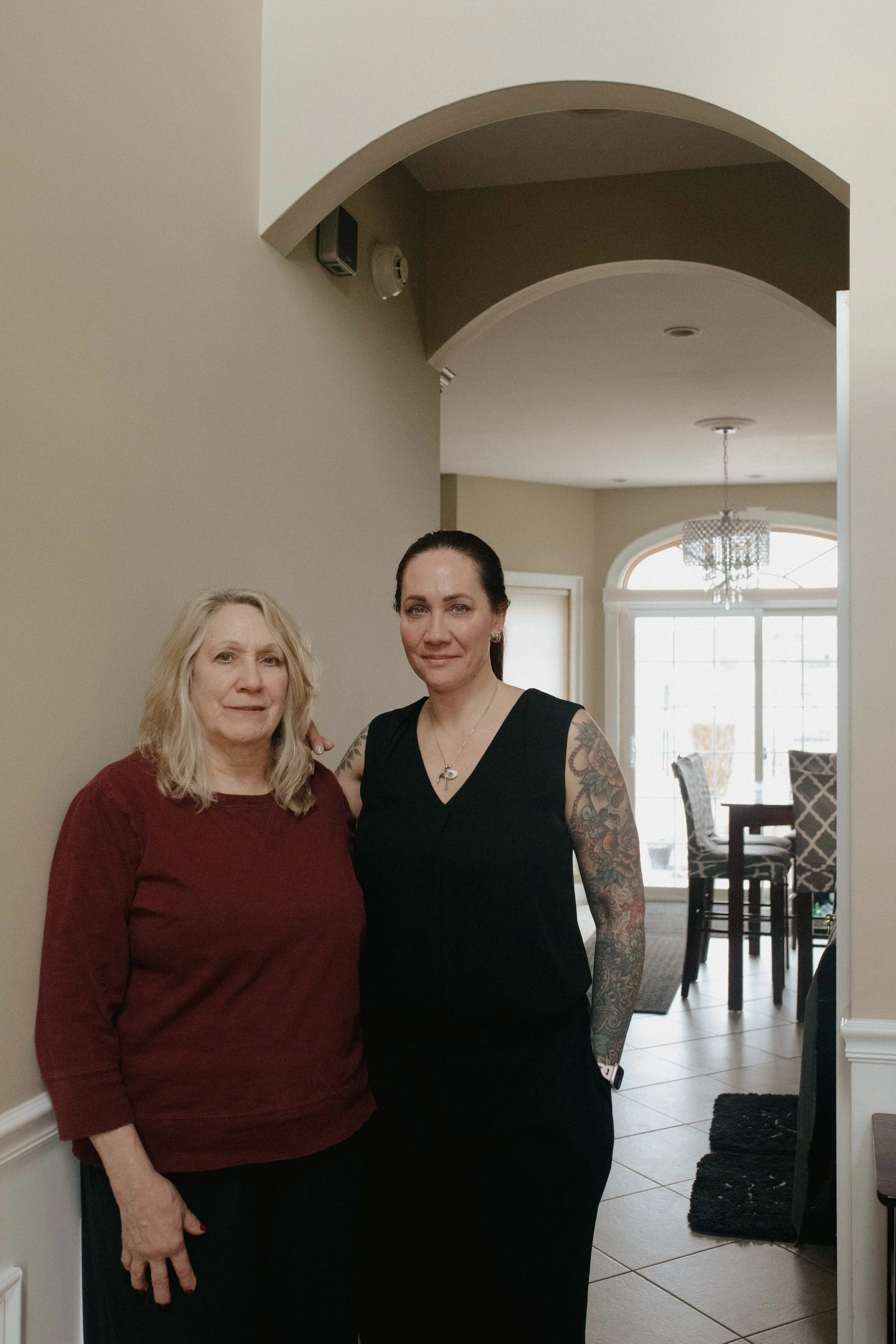 Jene Sena and her mom standing in the entryway of a multigenerational house