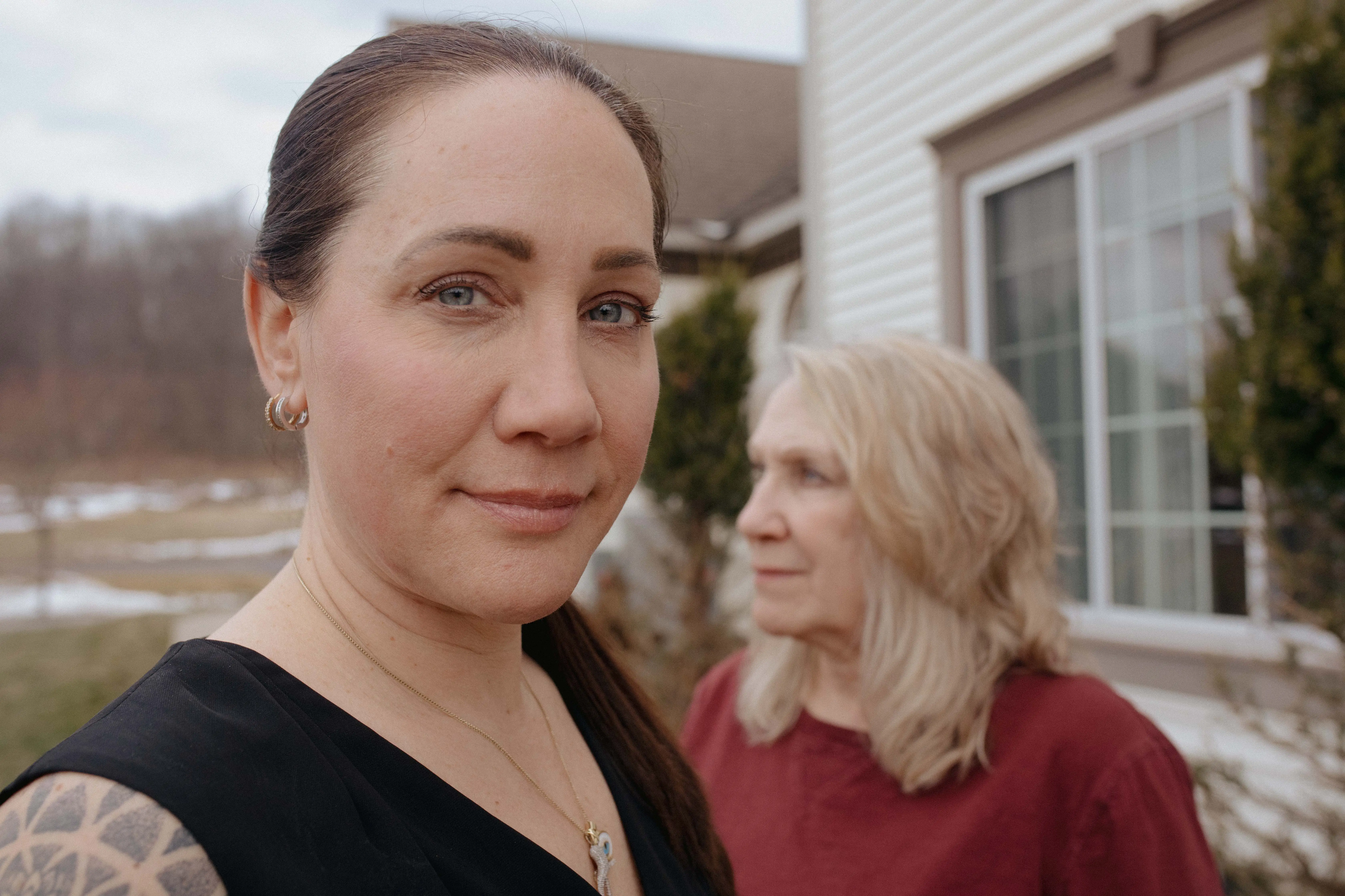 Jene Sena and her mother in front of their house