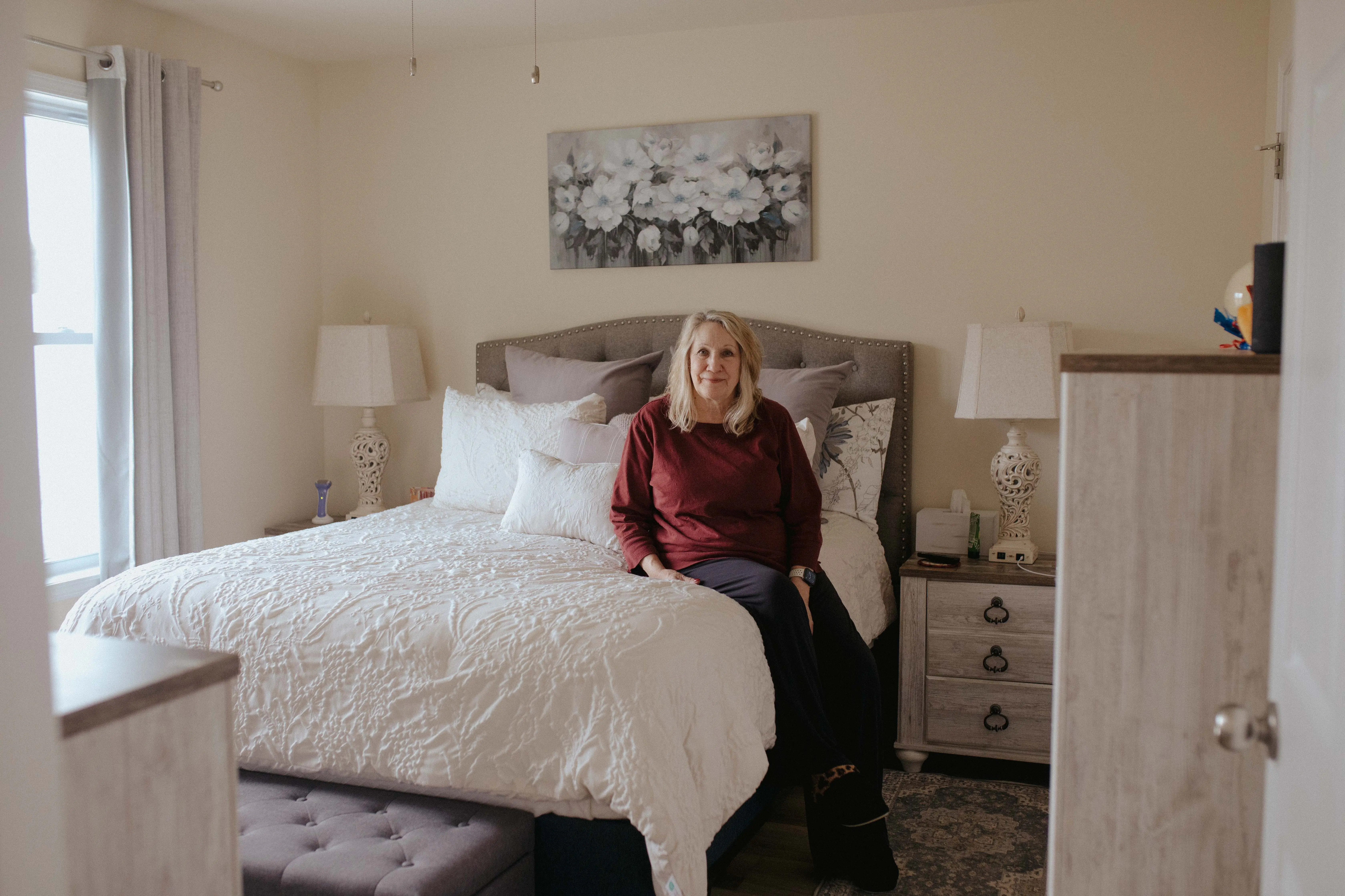 Jene Sena's mother sitting on her bed