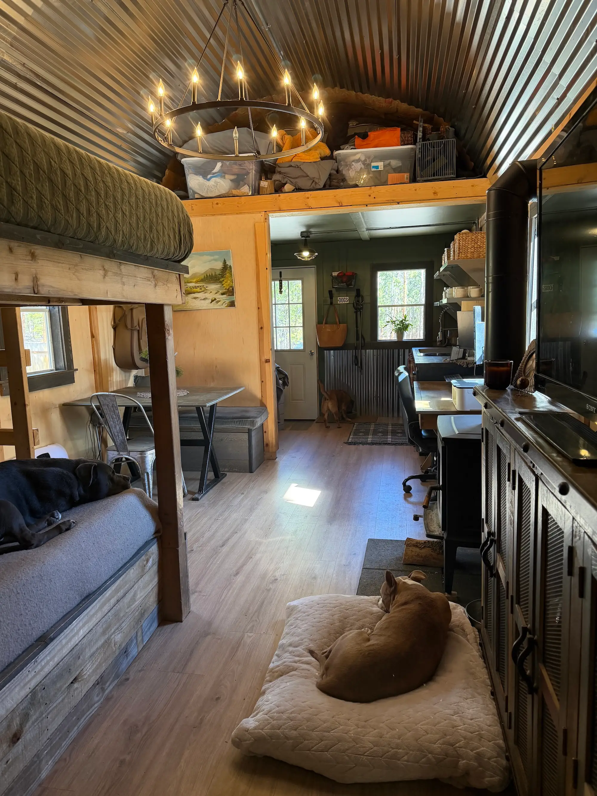 A tiny home with storage in a loft above the living space.