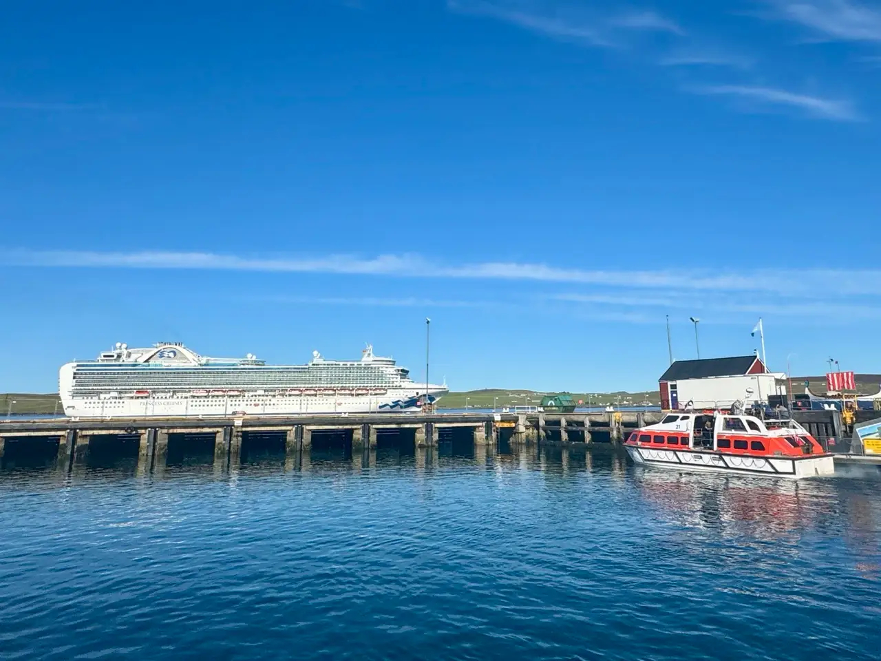 Water shuttle docked with ship in background L