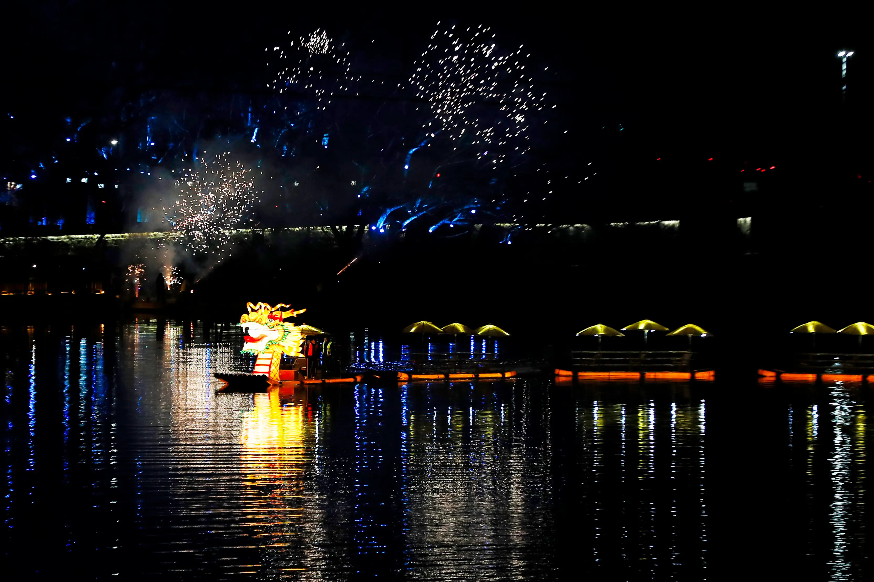 view of dragon boat, fireworks during lunar new year at sea