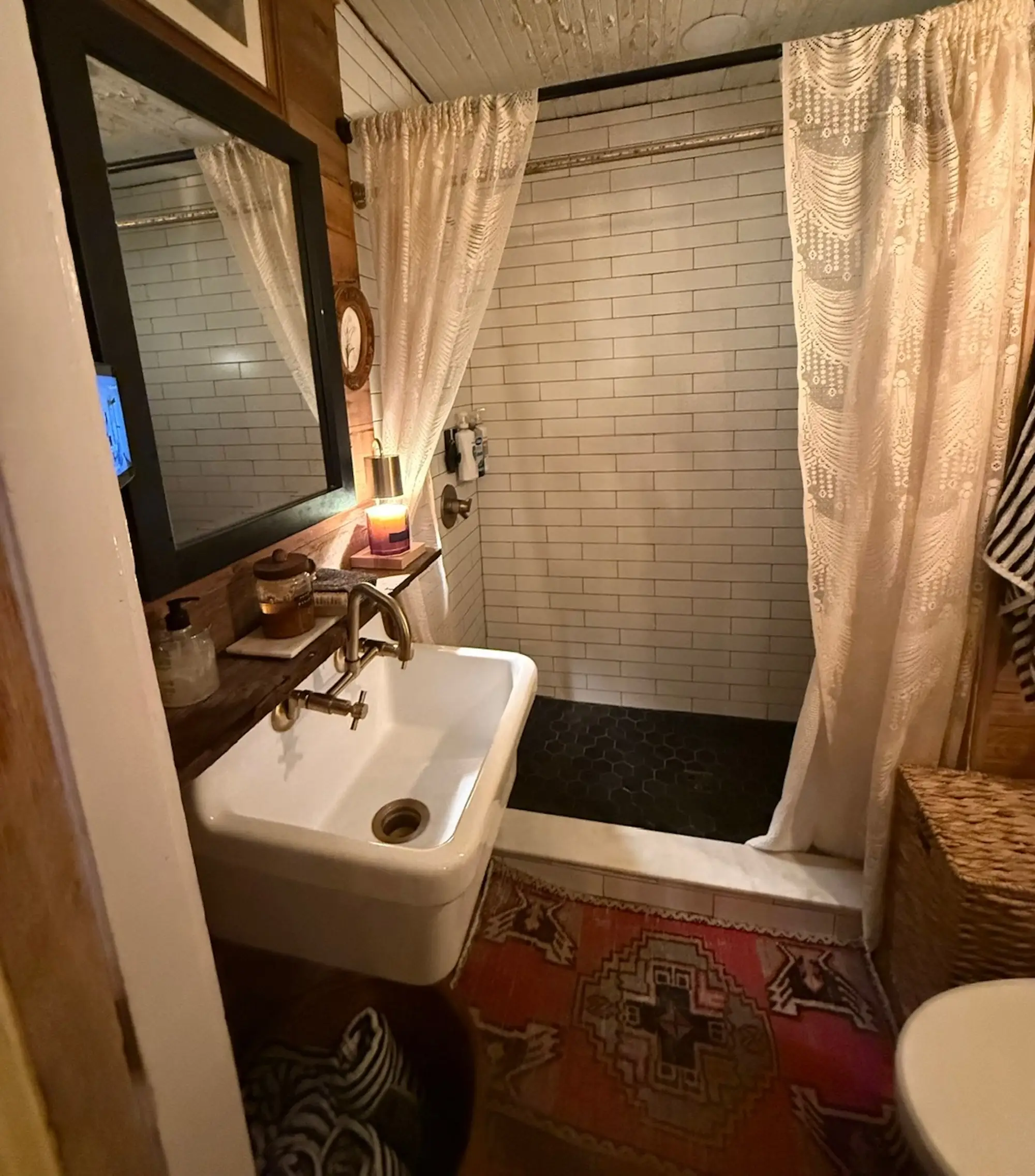 A sall bathroom with a sink, toilet, and shower.