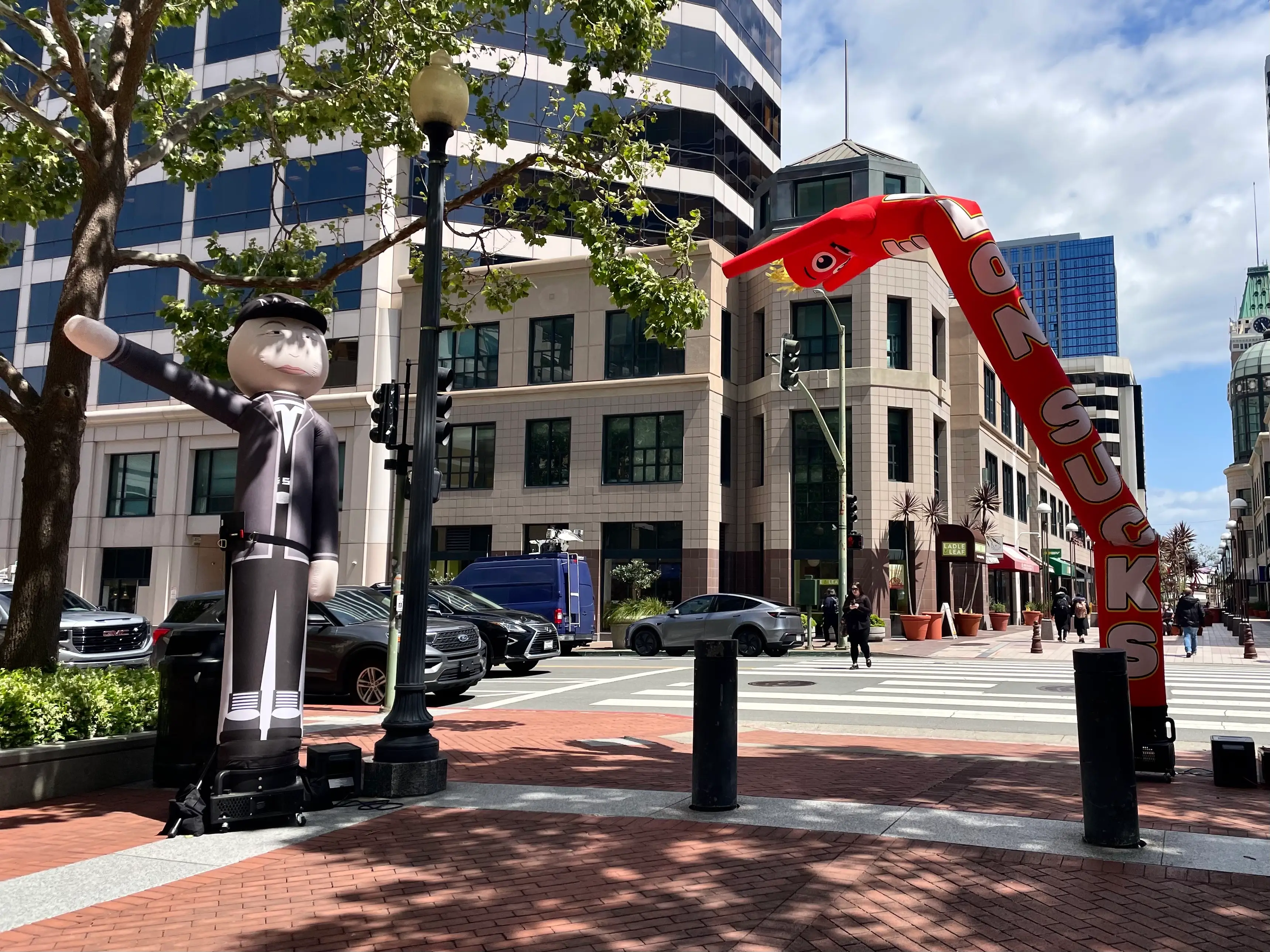 Inflatables mocking Elon Musk outside the federal building in Oakland.