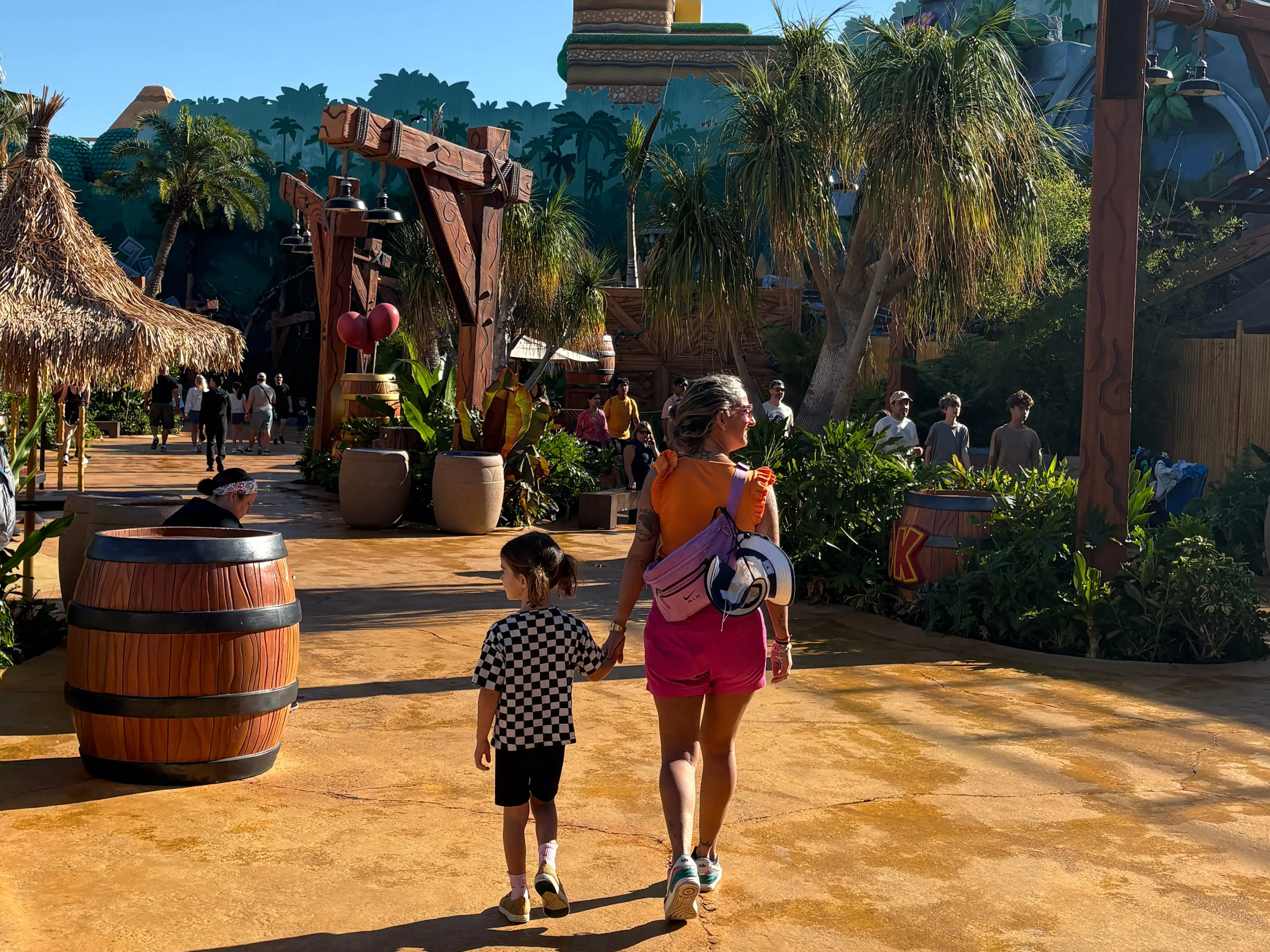 Mom walking with child through Epic Universe