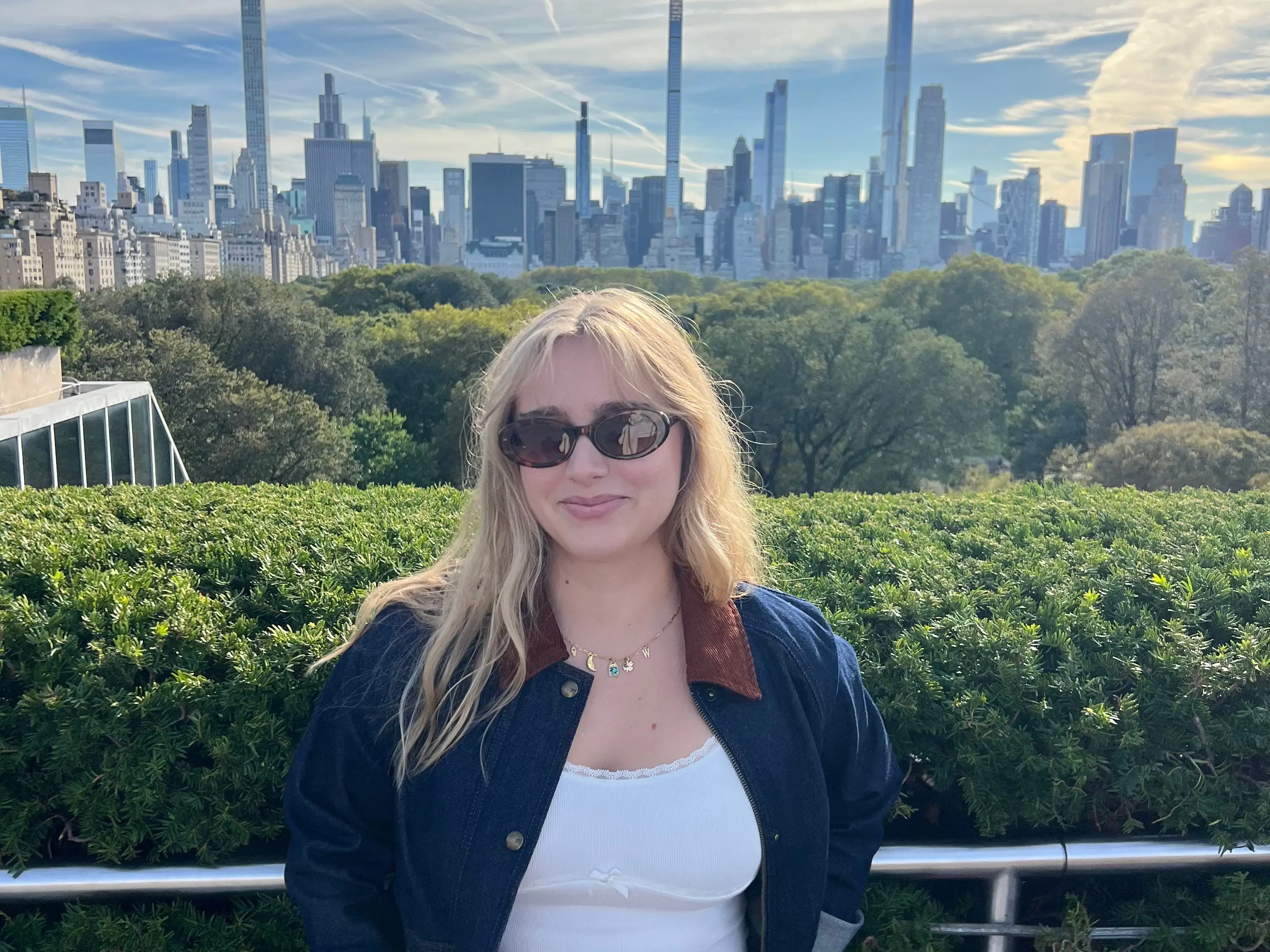 Ryan poses on a rooftop overlooking the New York City skyline.