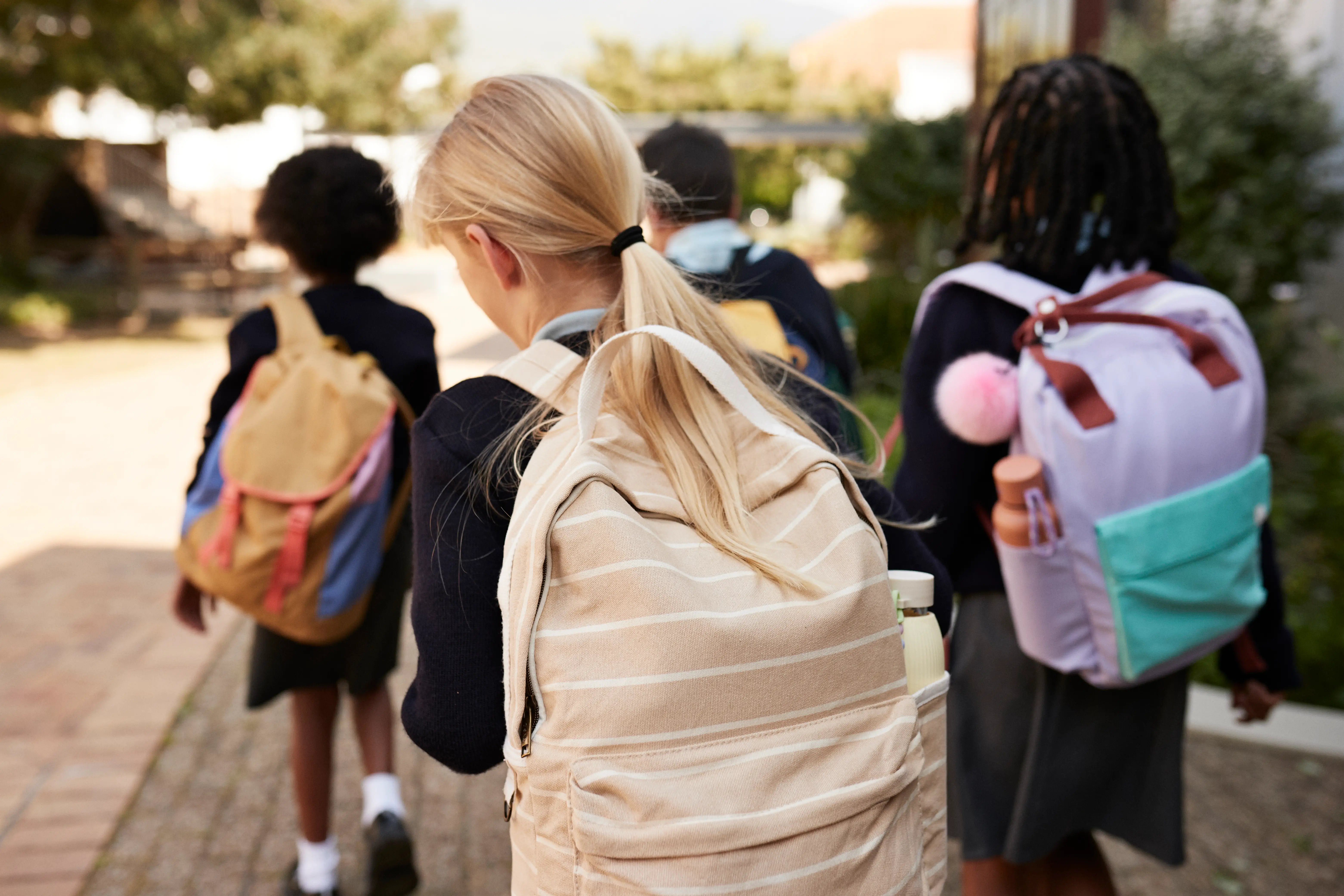 Girls walking alone to school.