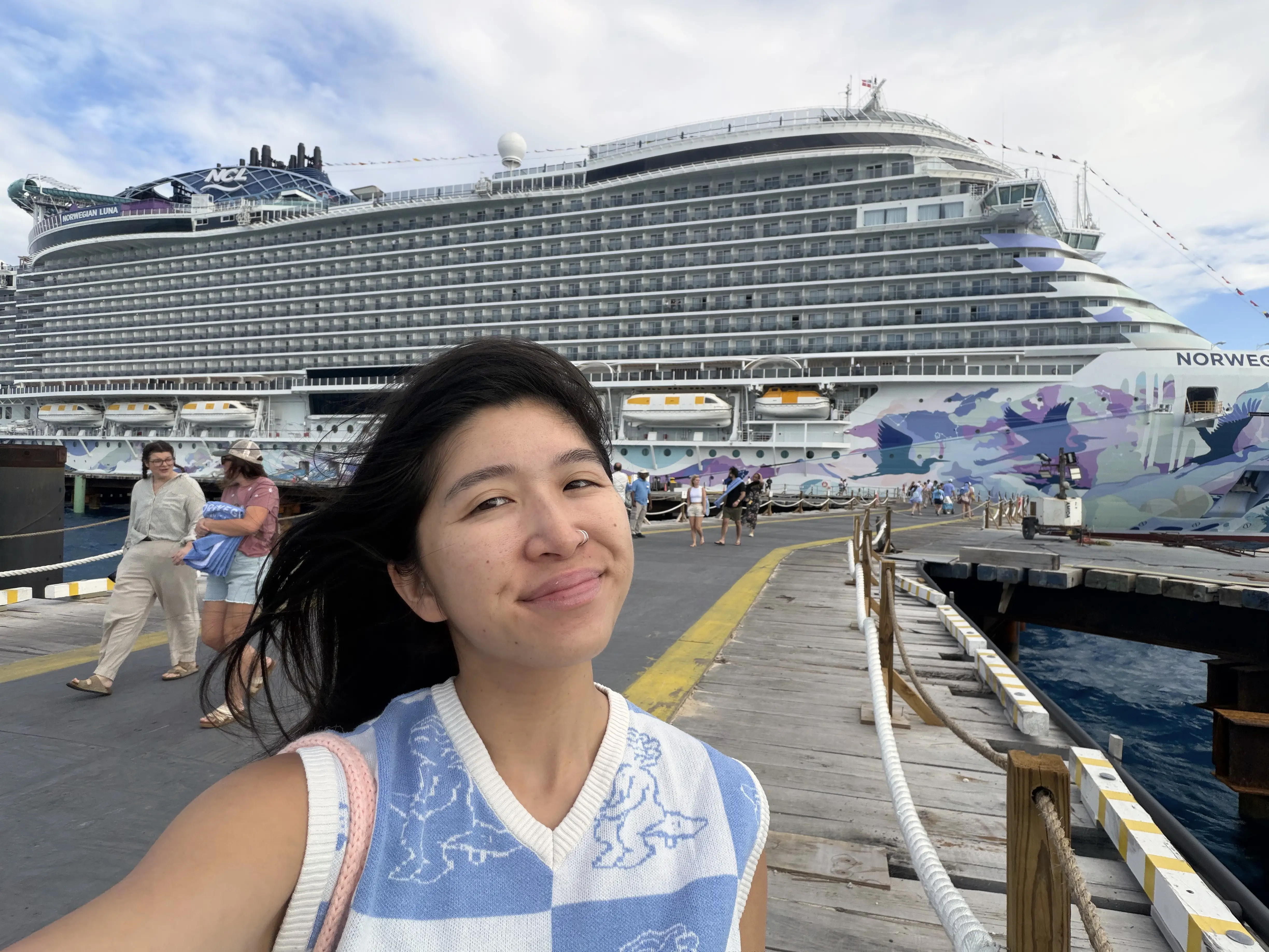 Author Brittany Chang smiling in front of Norwegian Luna ship