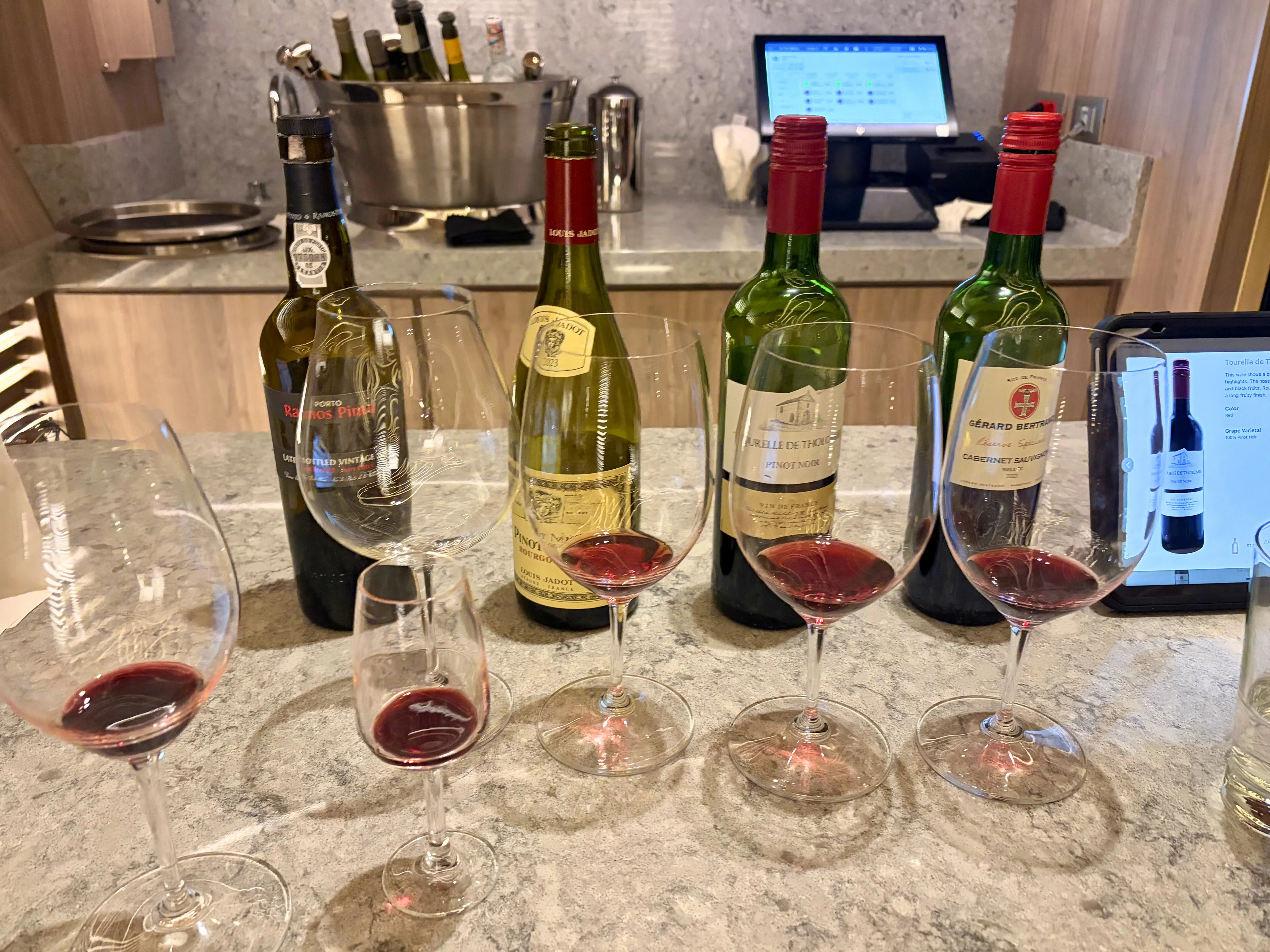 wine bottles behind glasses with sips poured into them