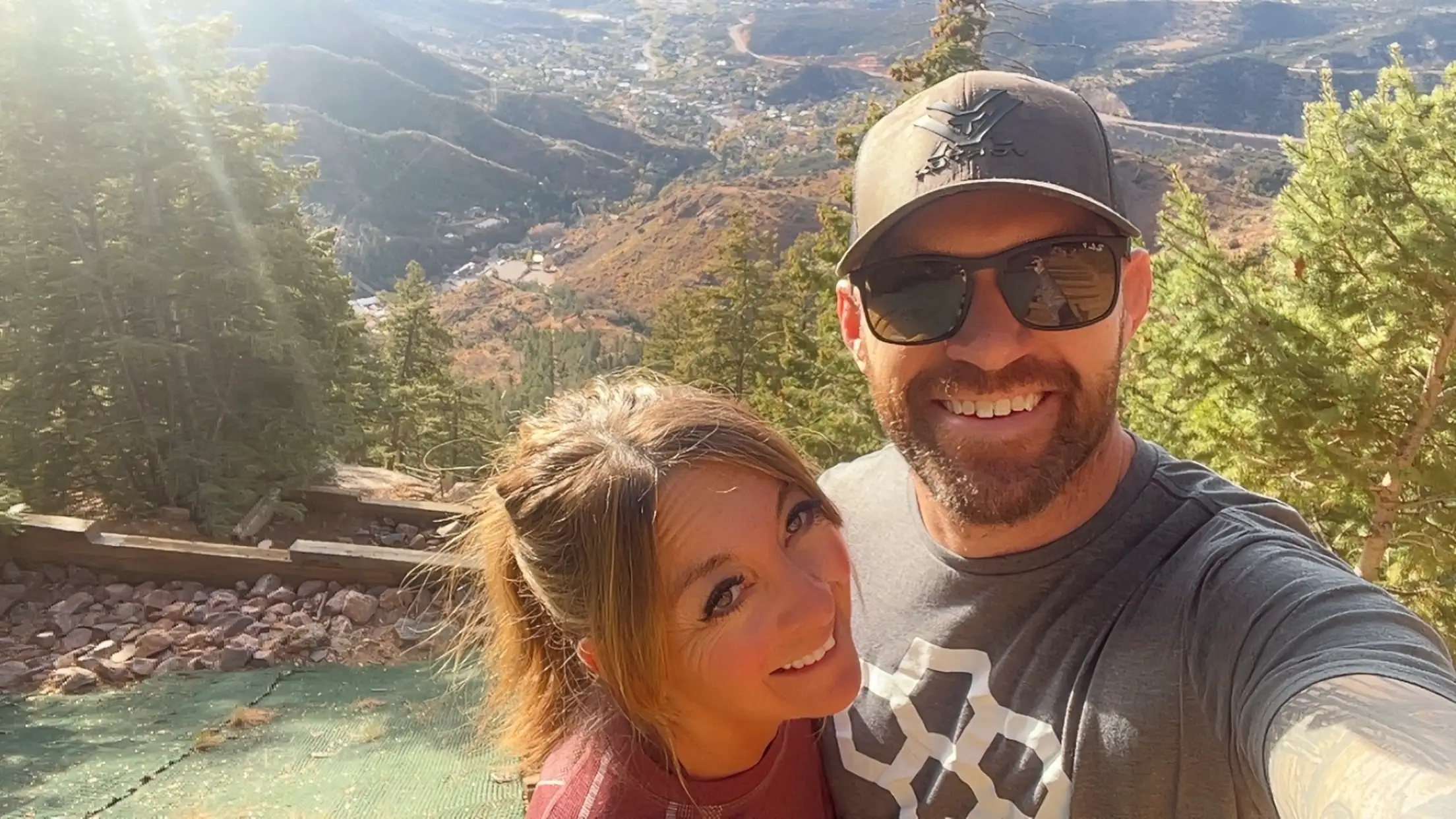 A selfie of a couple in a mountainous area.