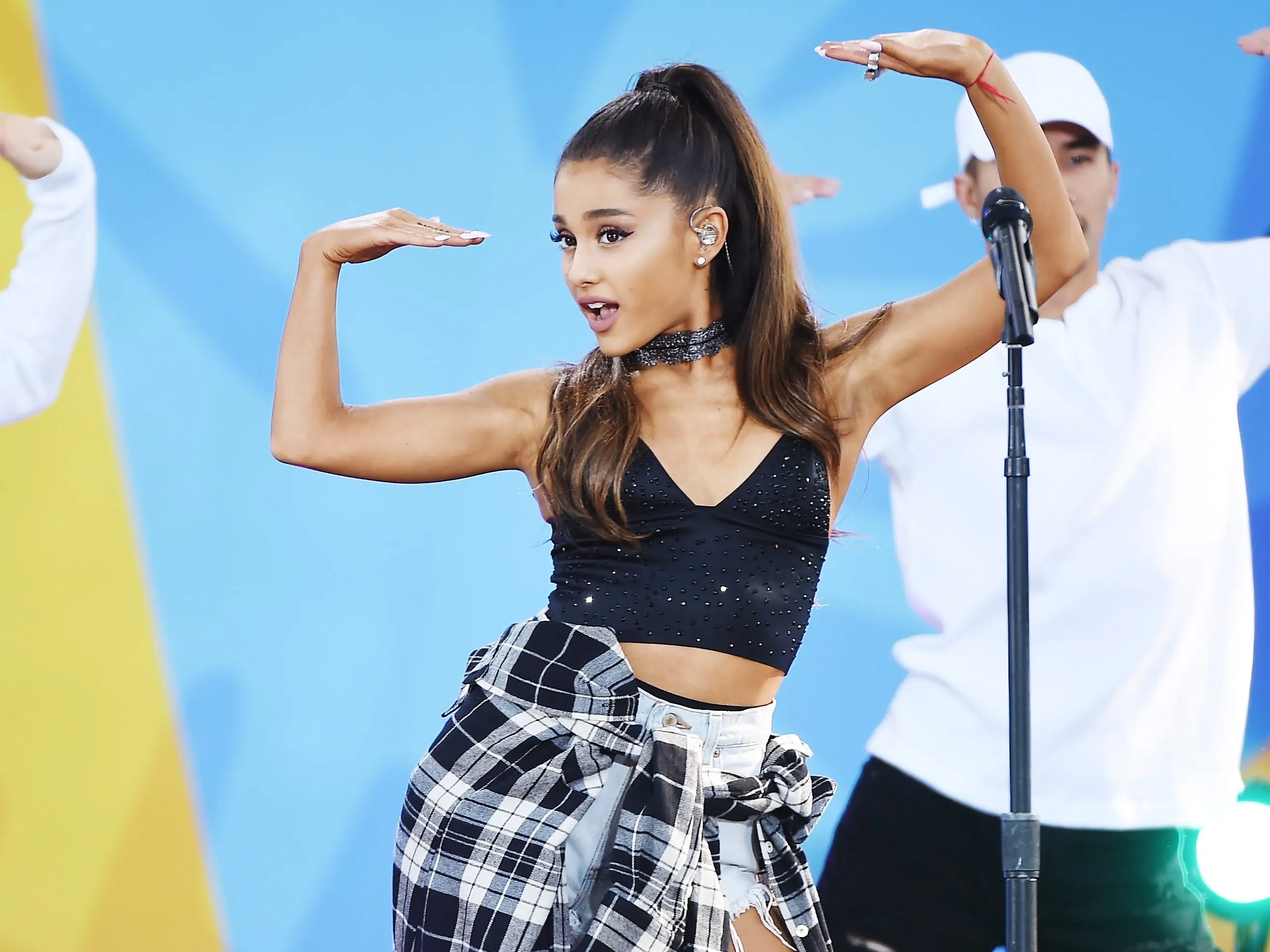 Ariana Grande making a pose during a performance.
