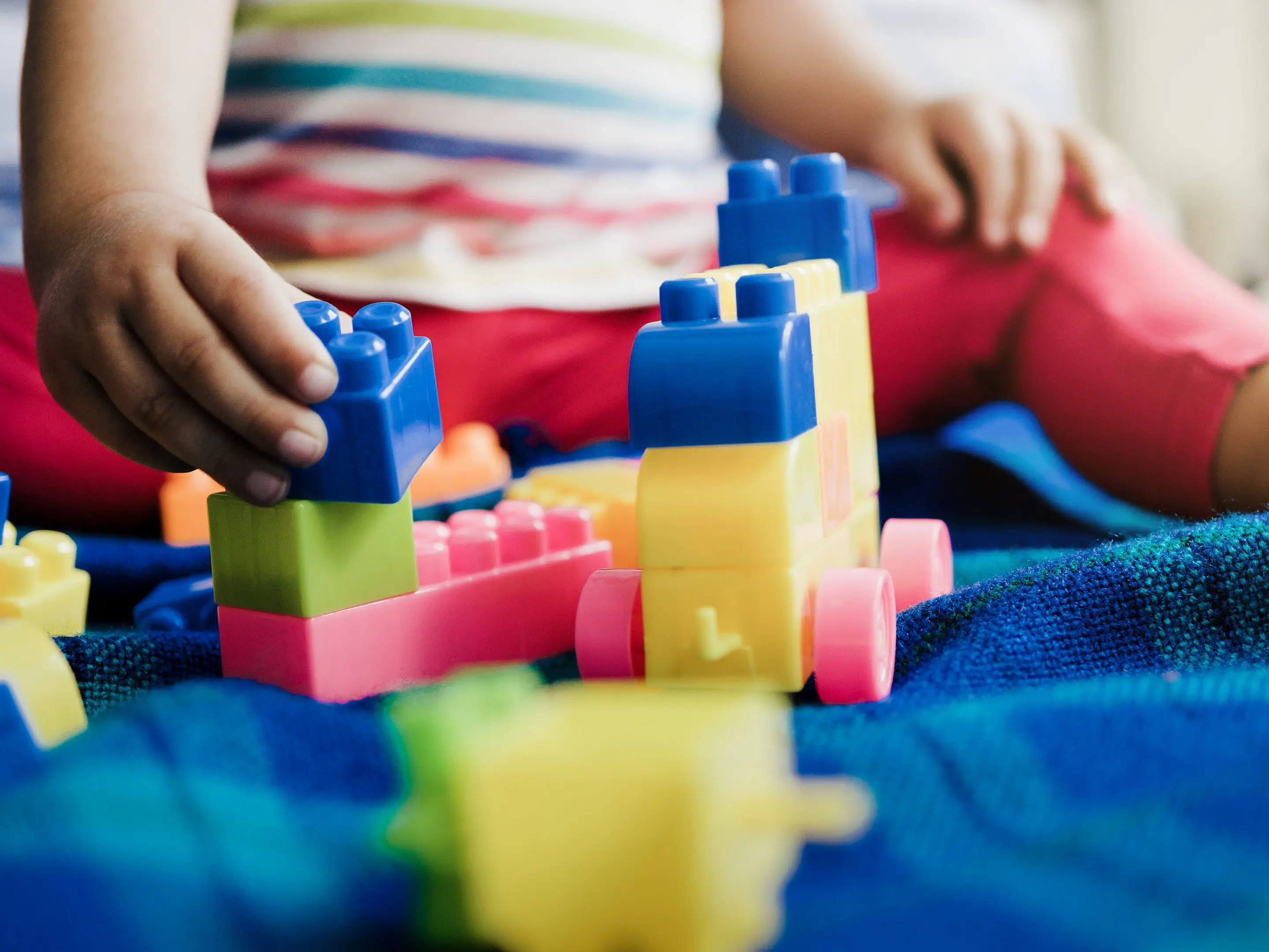 A child playing with brick toys