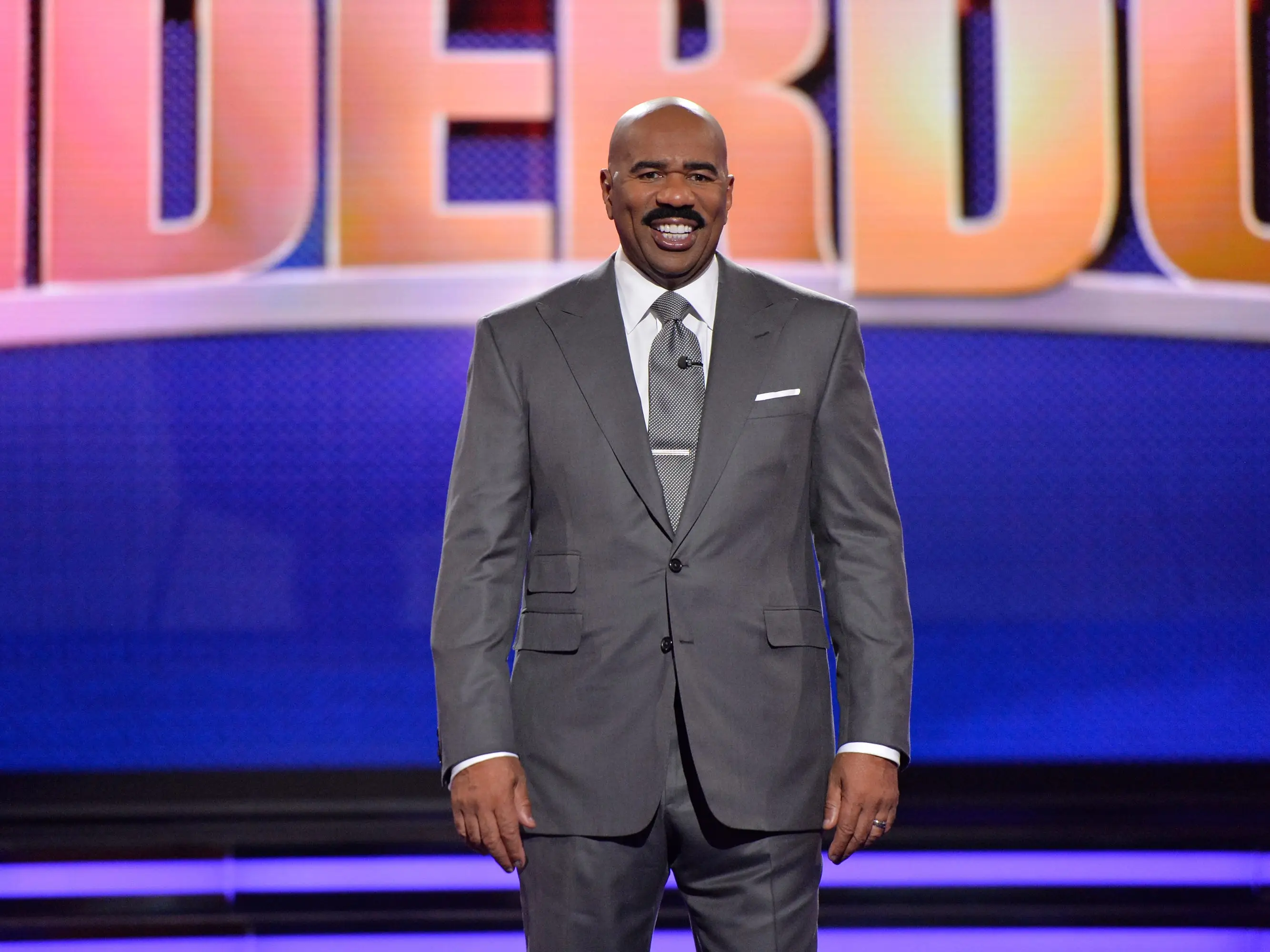 Steve Harvey poses on the set of an ABC game show.