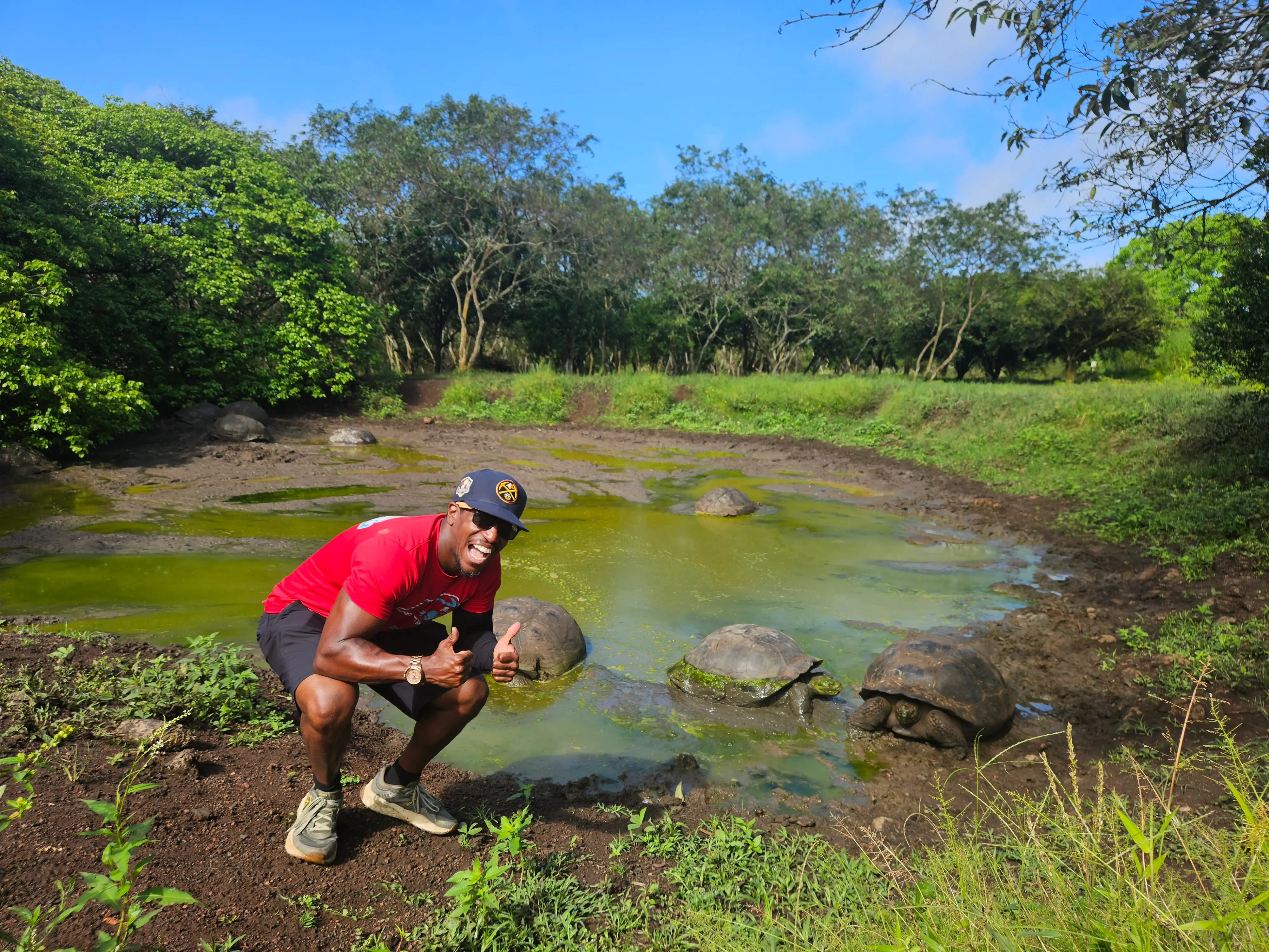 Man posing with turtle in galapagos