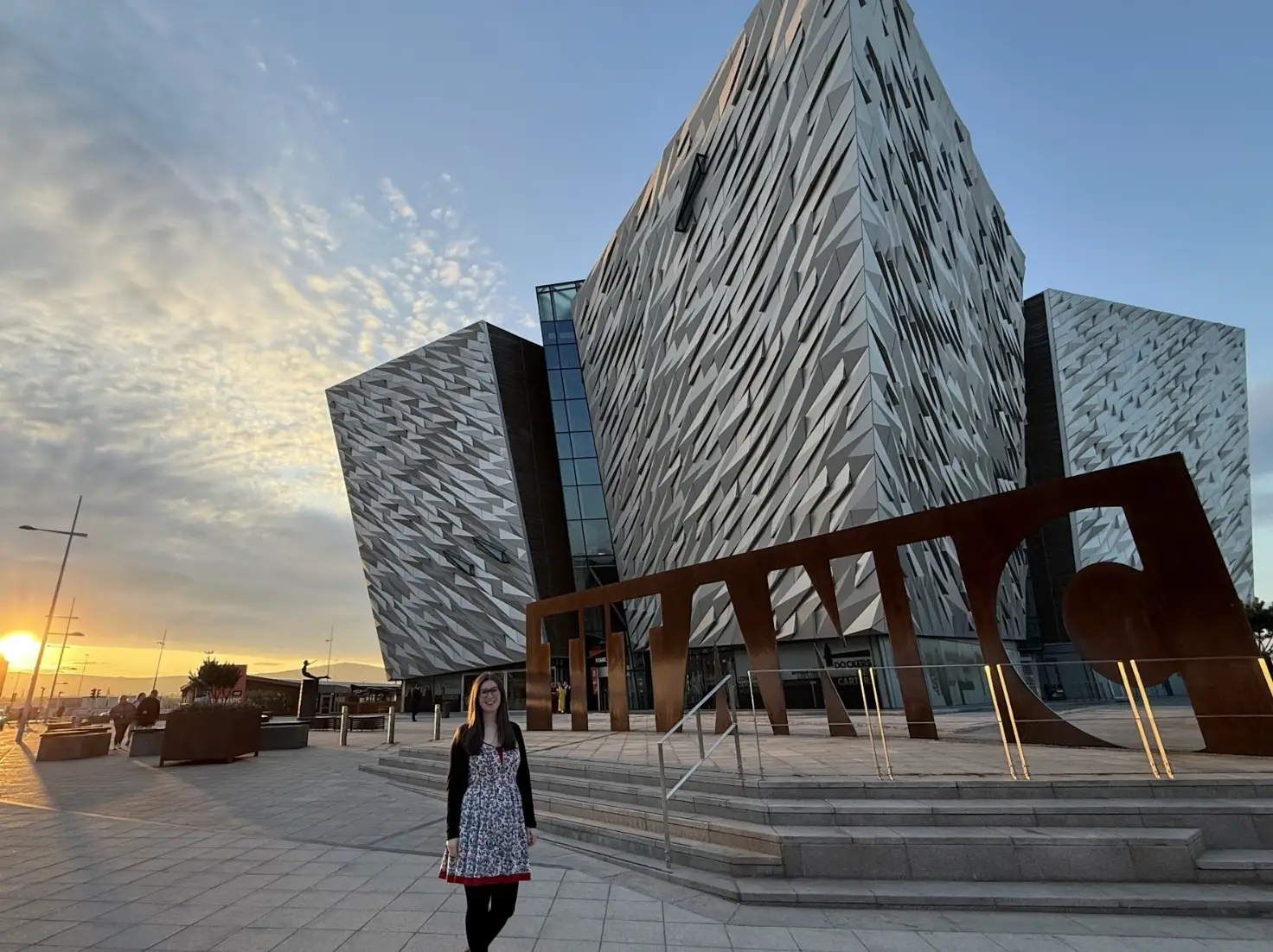 The writer standing in front of Titanic Belfast in Northern Ireland.