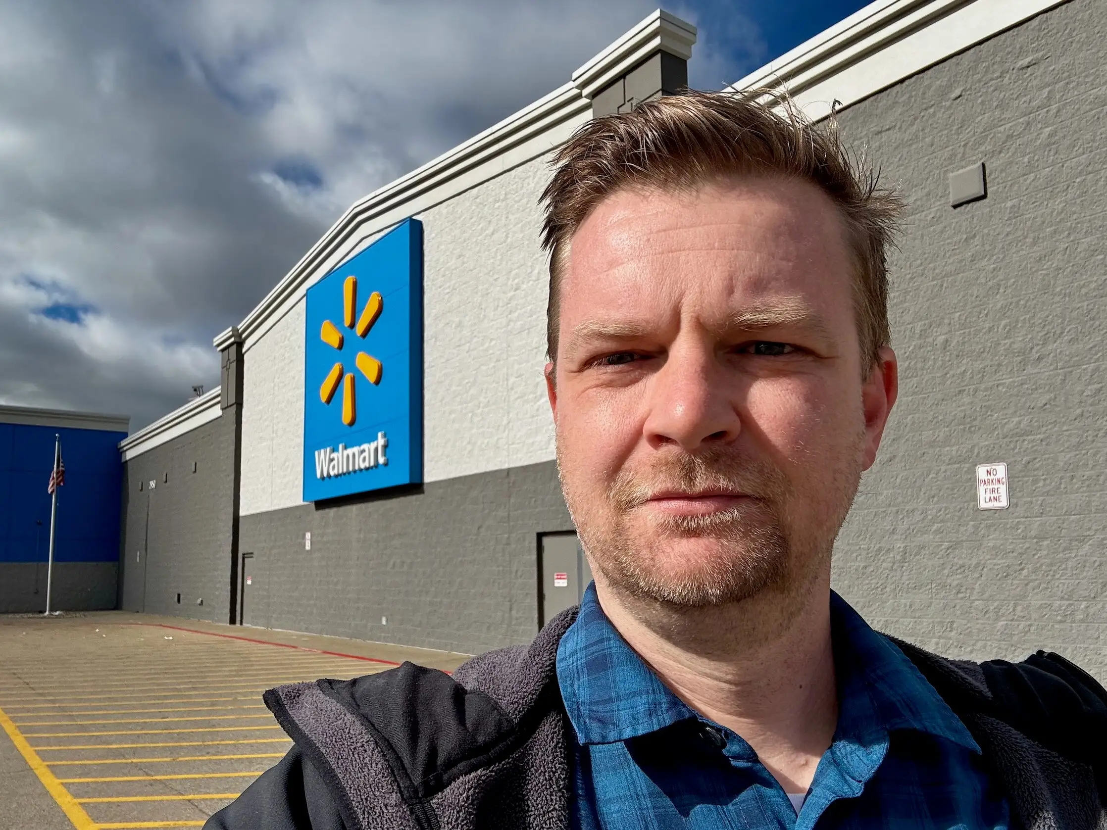 Dominick Reuter outside a Walmart store with the blue logo sign visible on the building.