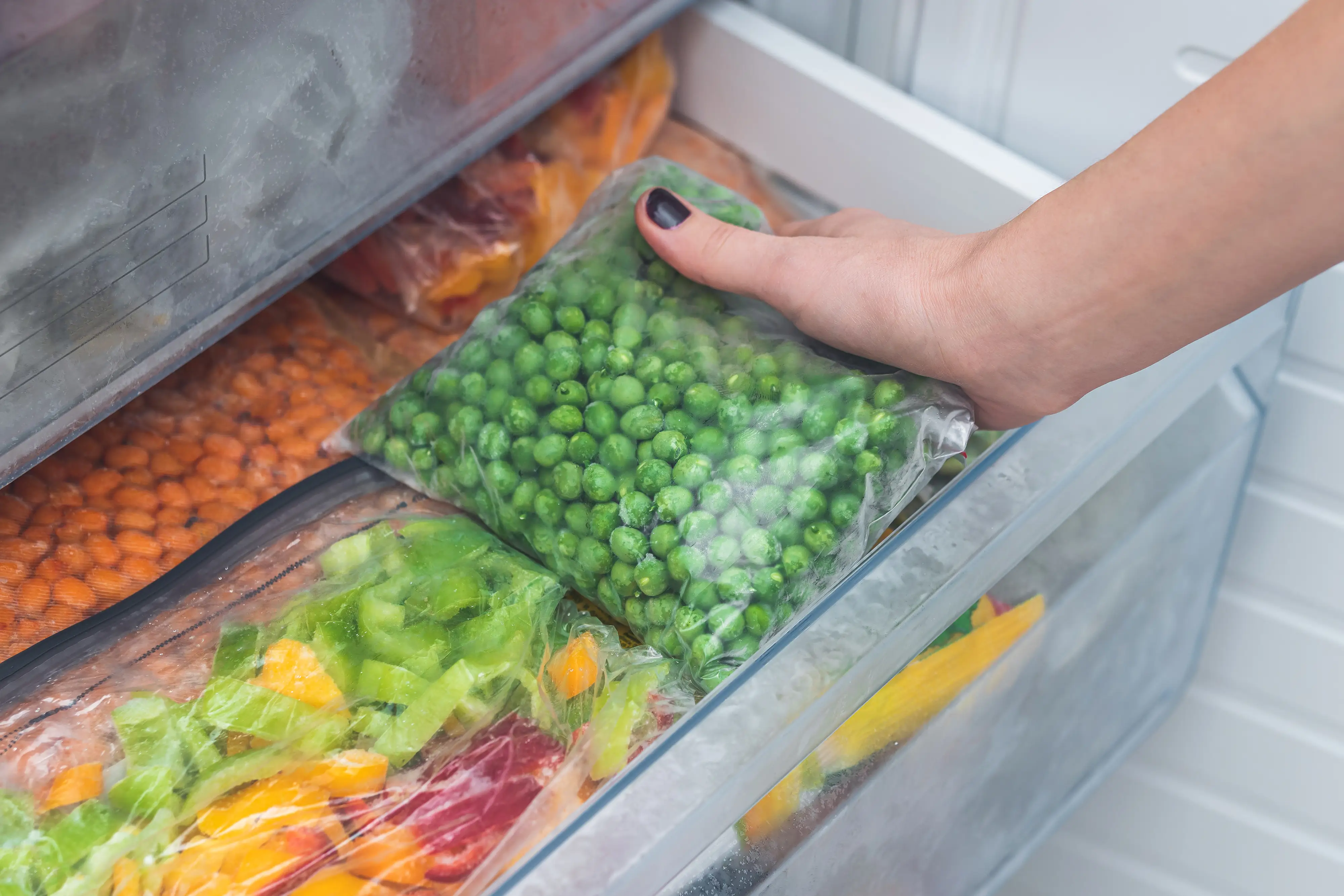 frozen peas being pulled out of freezer