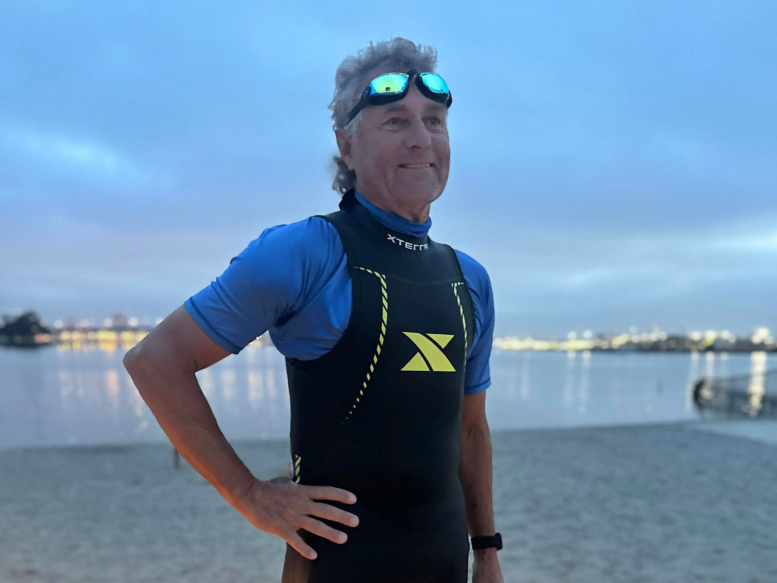 A man in a wetsuit on the beach