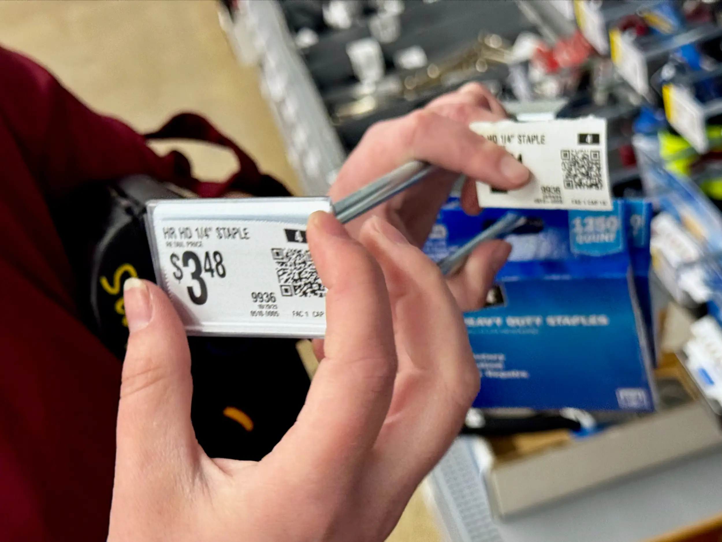 An employee swaps out a paper price tag.