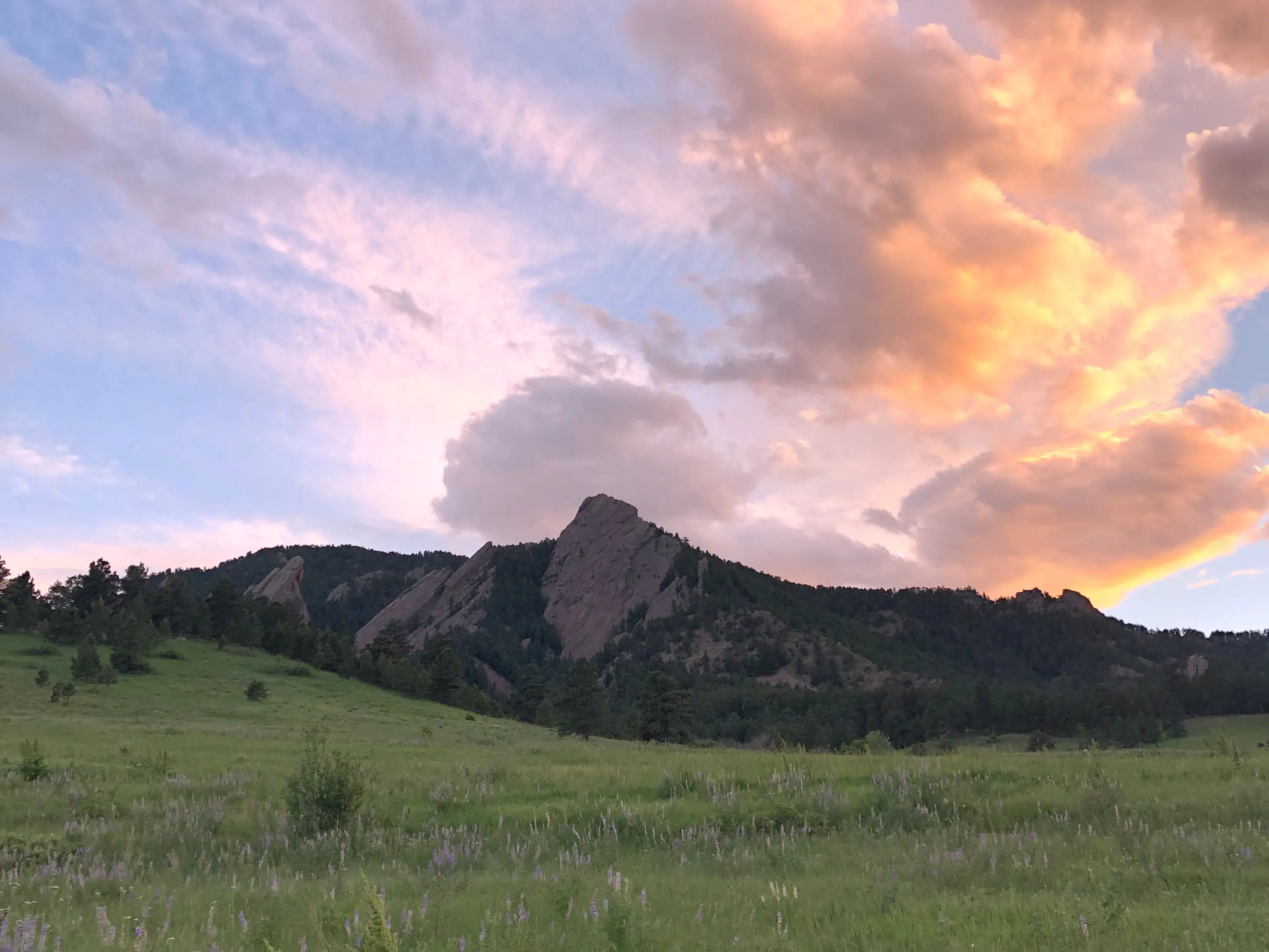 Sunset over a large rock formation.