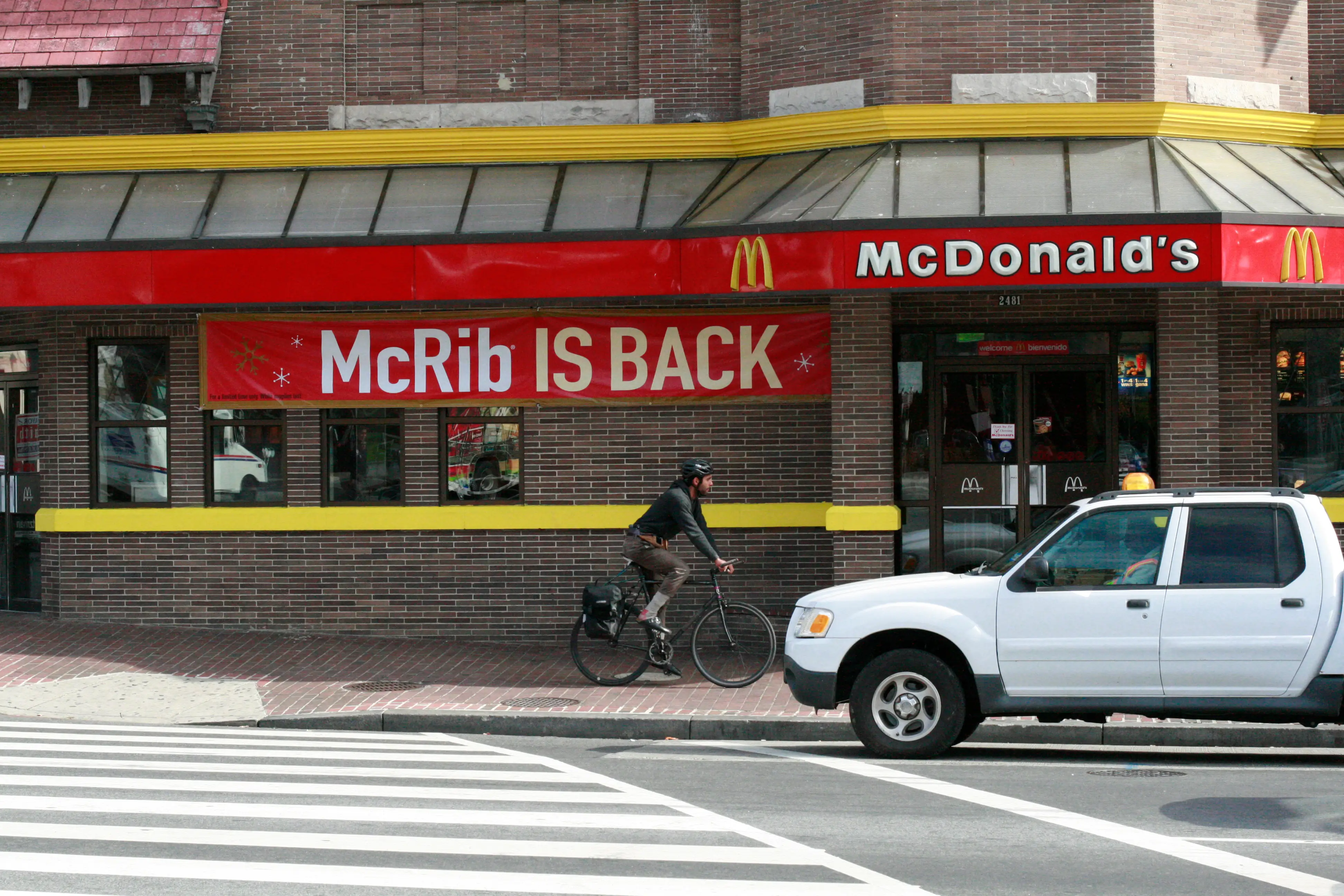A McDonald's restaurant with prominent signage featuring the return of the McRib sandwich.