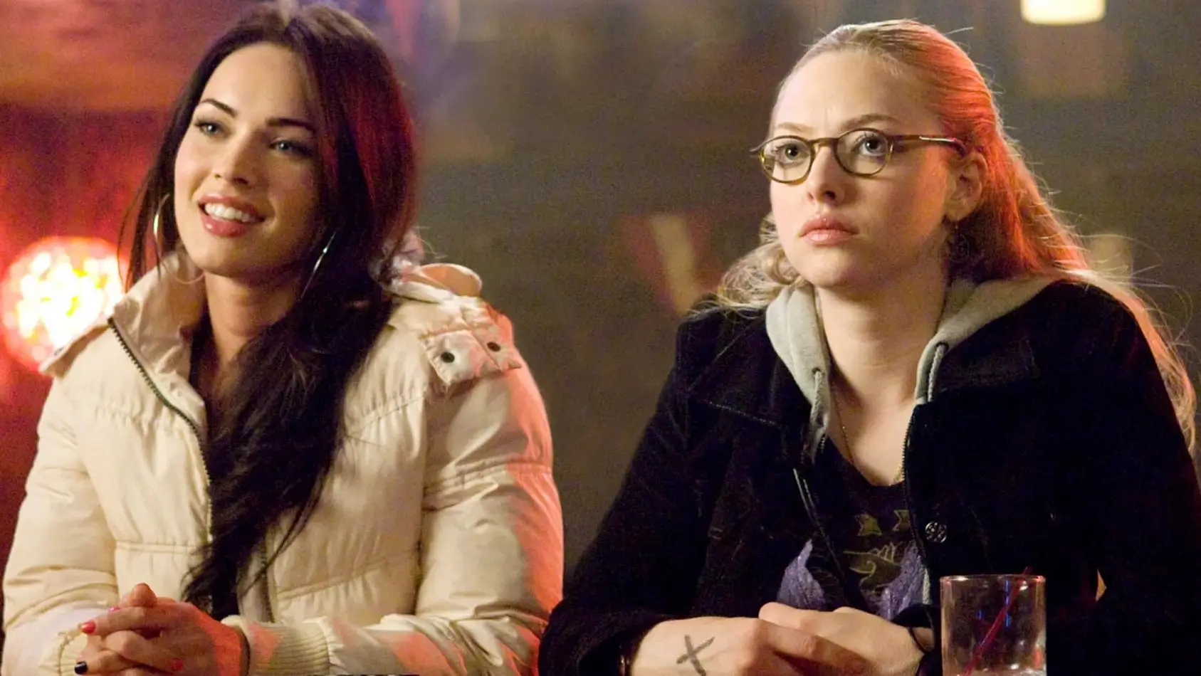 Megan Fox and Amanda Seyfried sitting in a bar