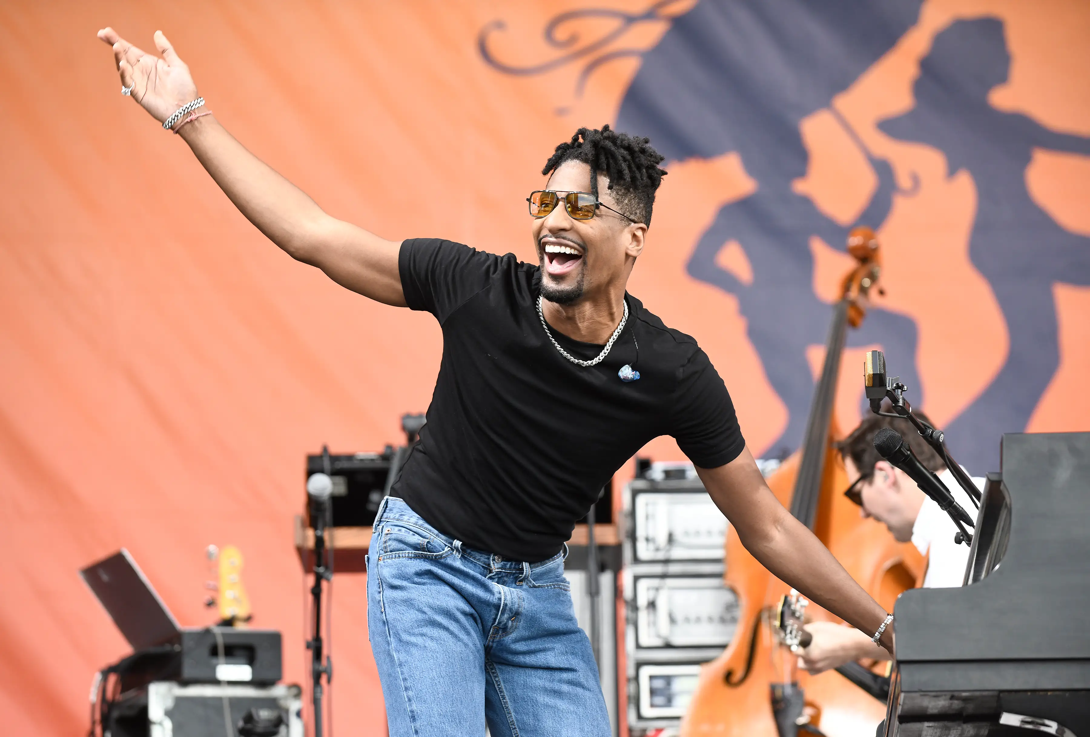 Jon Batiste playing the piano with a band