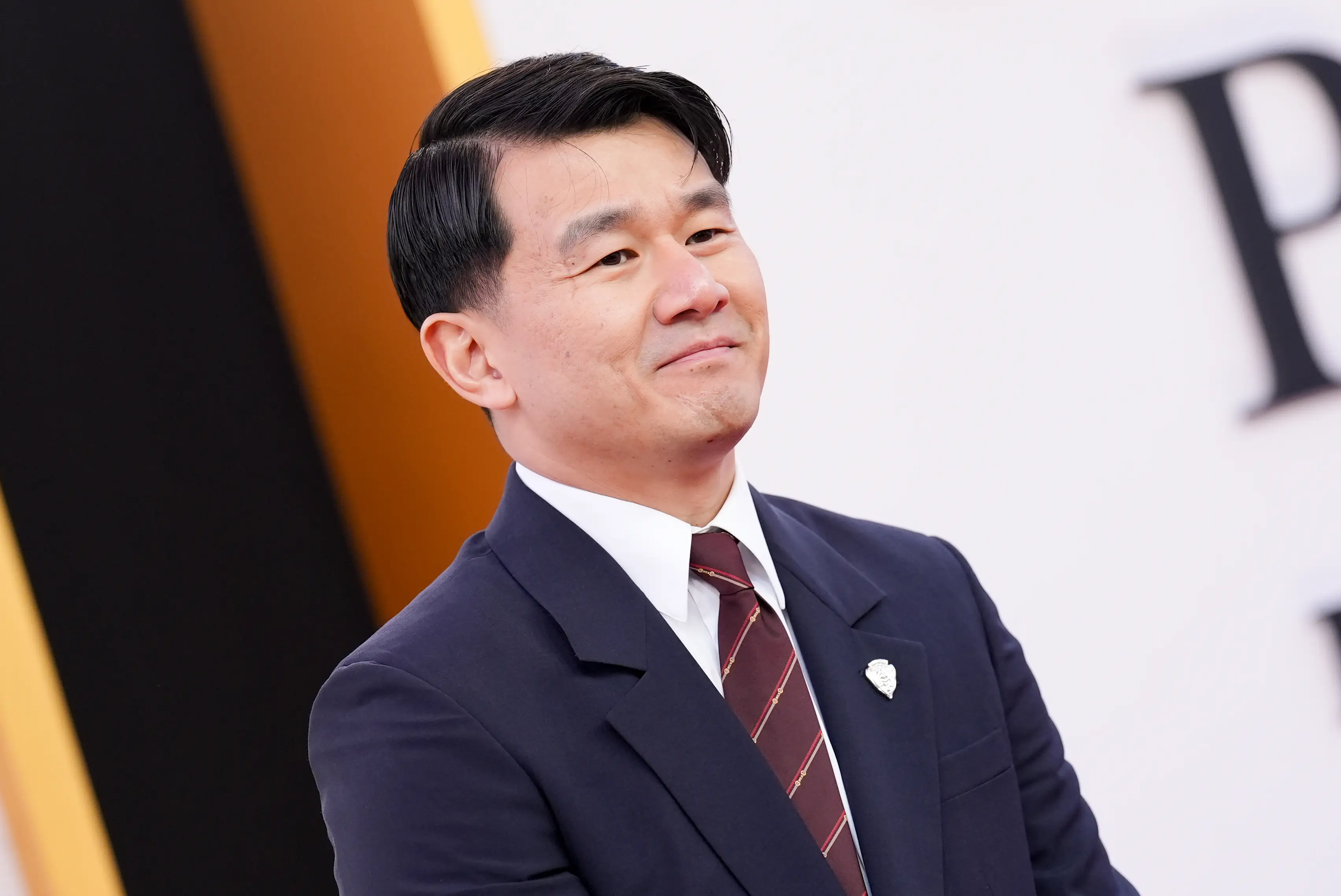 Ronny Chieng in a blue suit