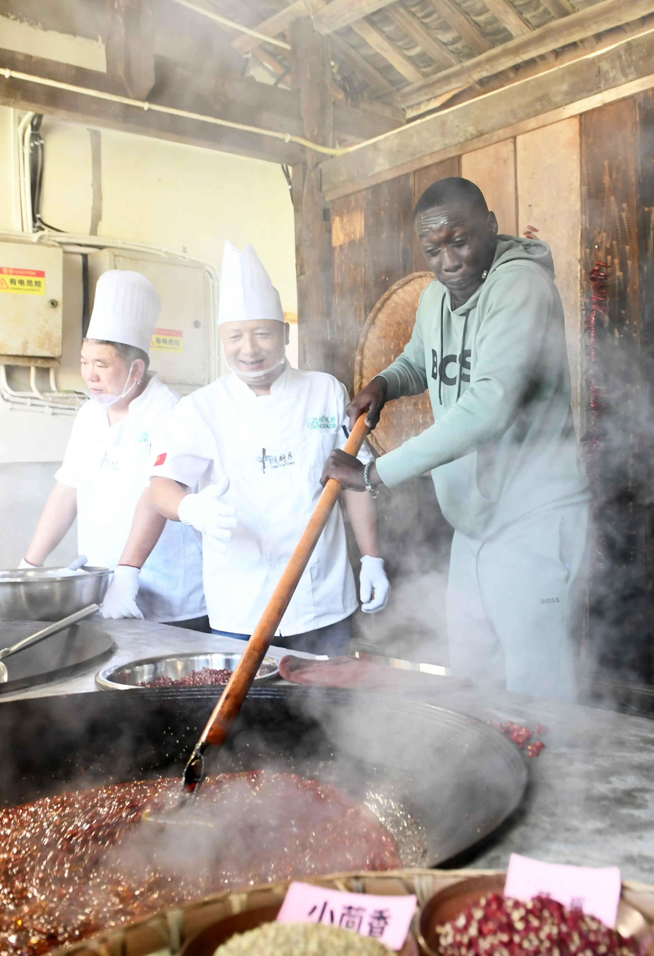 Khaby Lame stirred hot pot seasoning during his China visit.