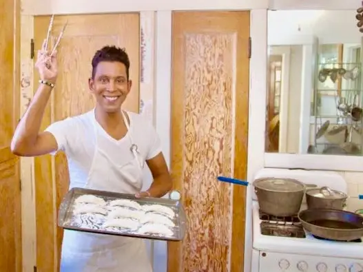 The author poses with empanadas he made for an event he hosted.