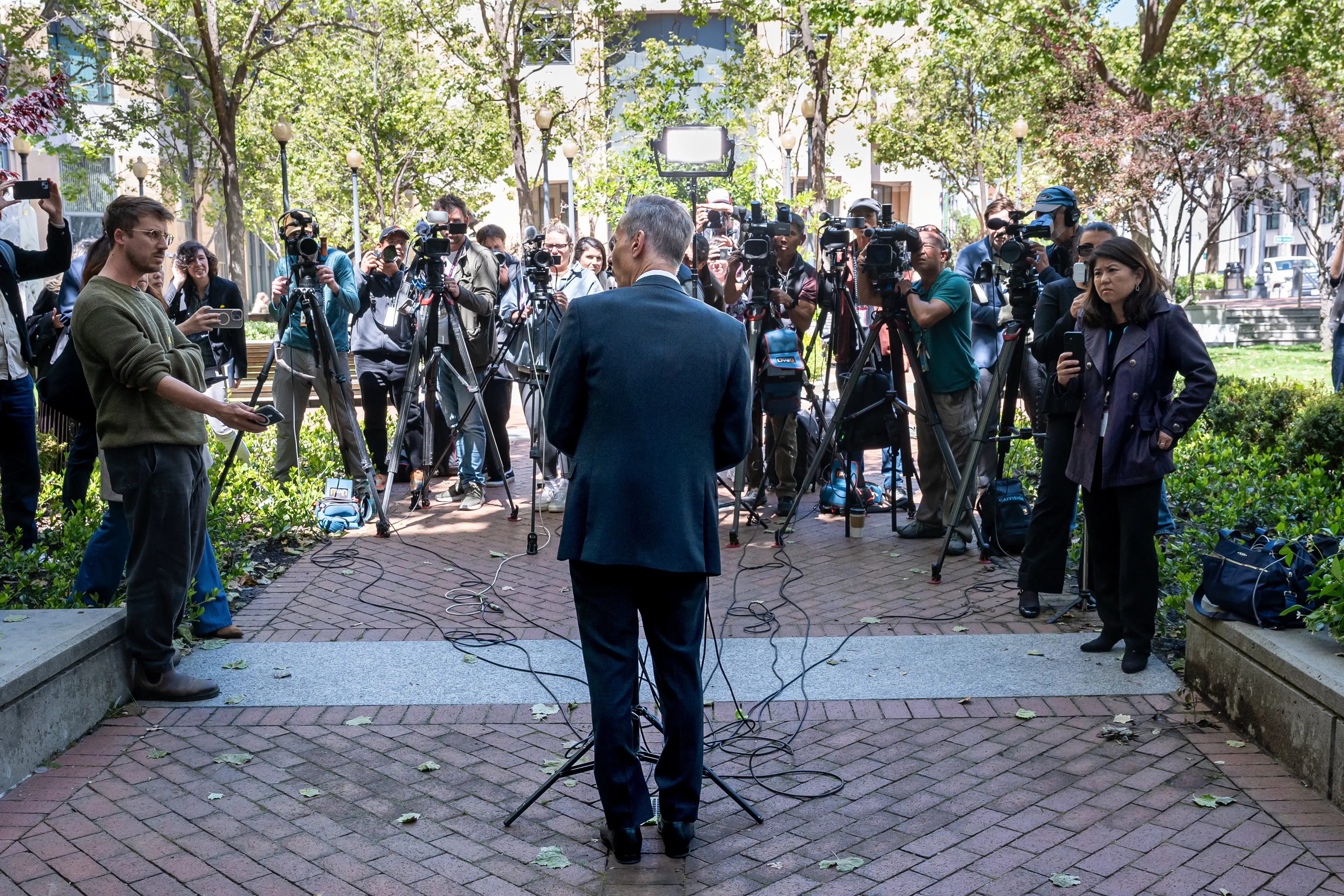 A lawyers faces the press outside court