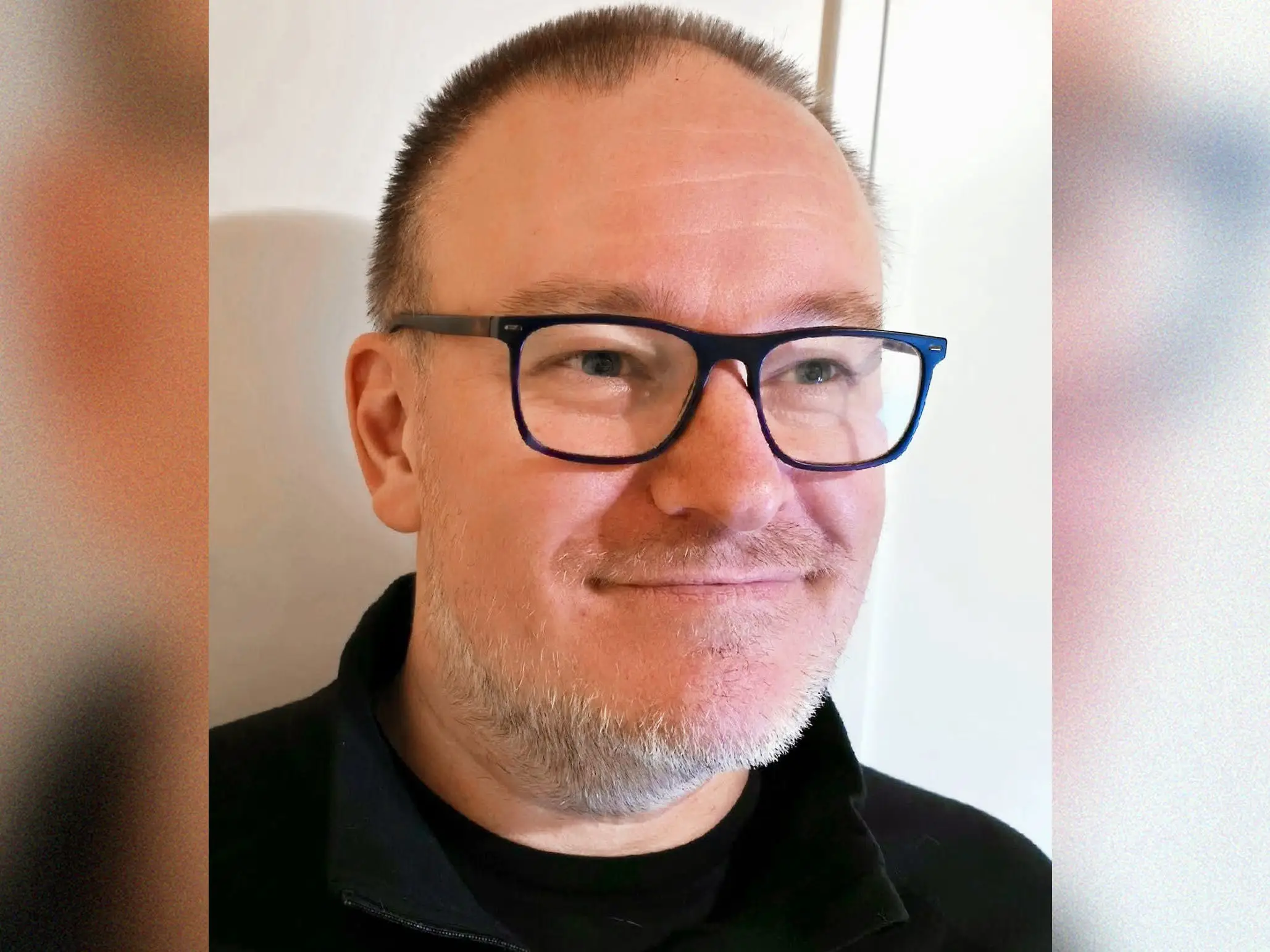 a head shot of a man in glasses