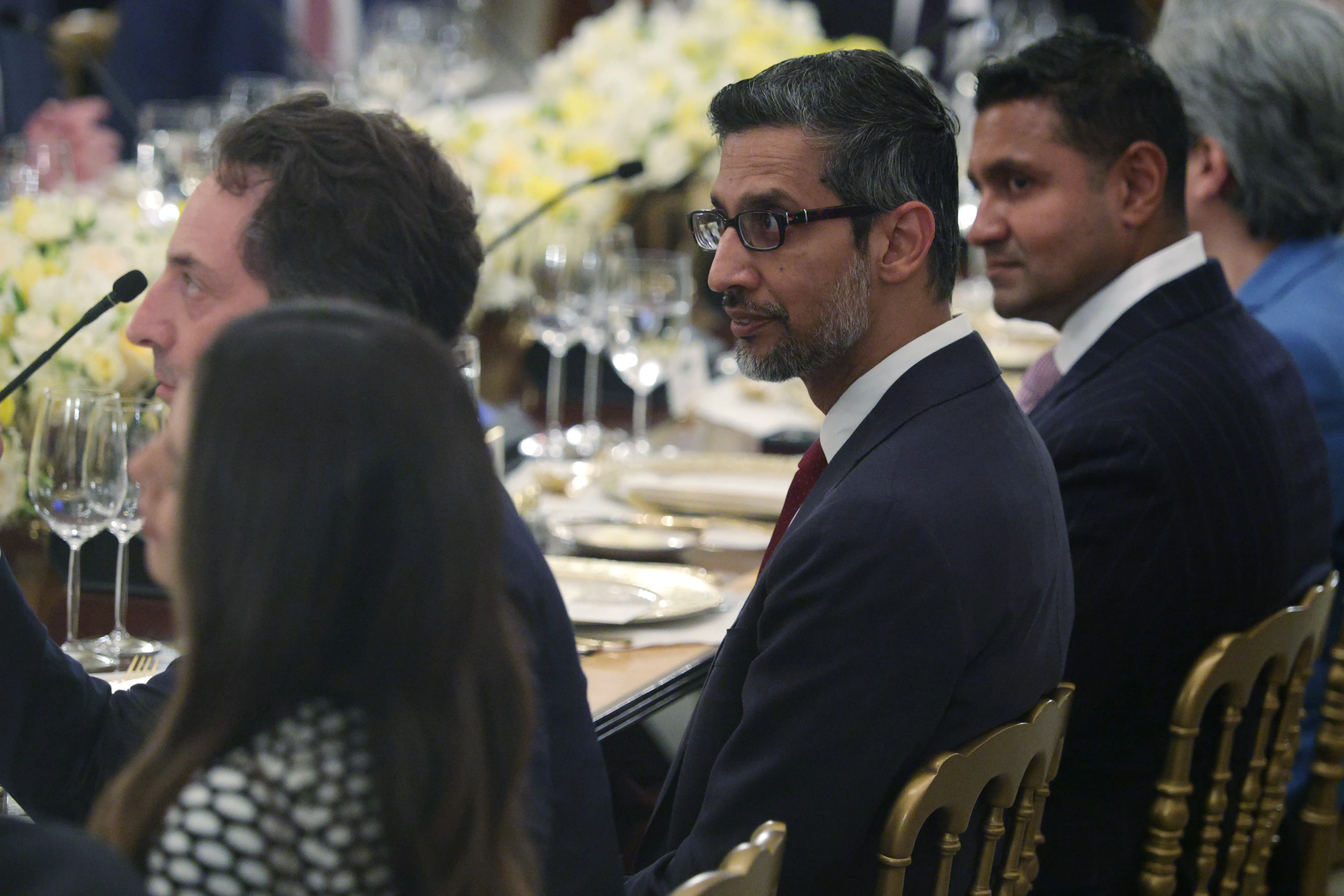 Google CEO Sundar Pichai listens during a dinner at the State Dining Room of the White House on September 4, 2025