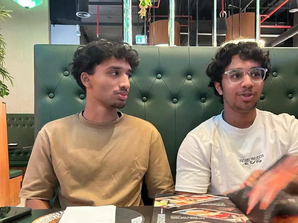 Brothers sitting at a both in a restaurant.