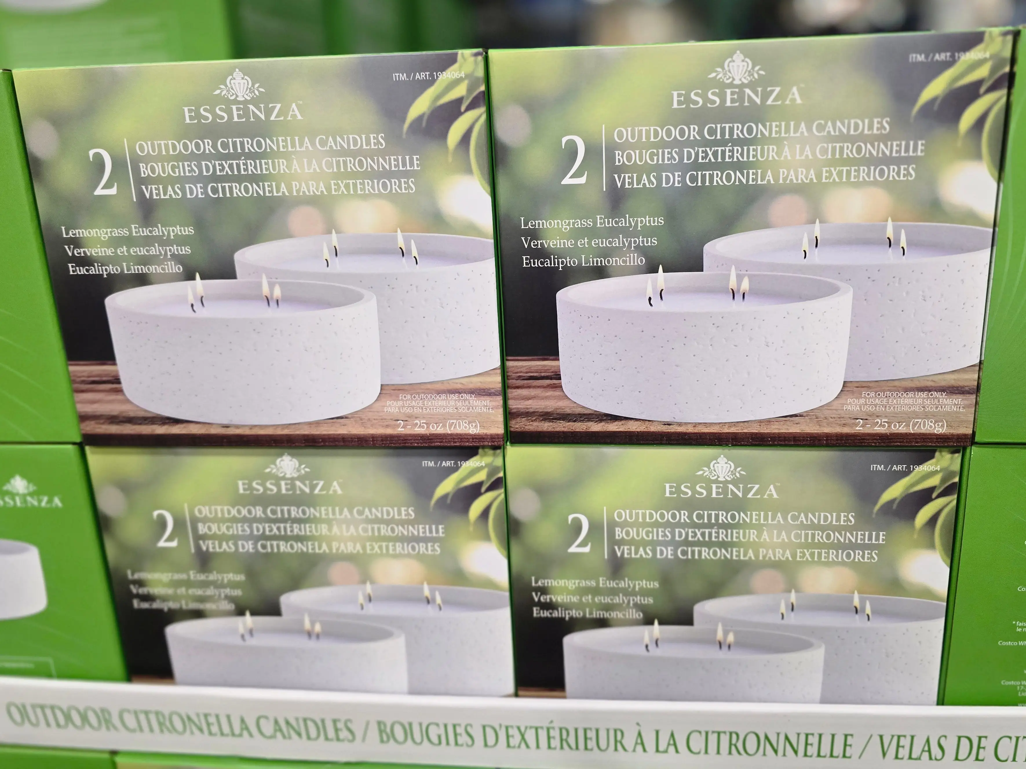 Boxes of Essenza outdoor citronella candles on display at Costco.