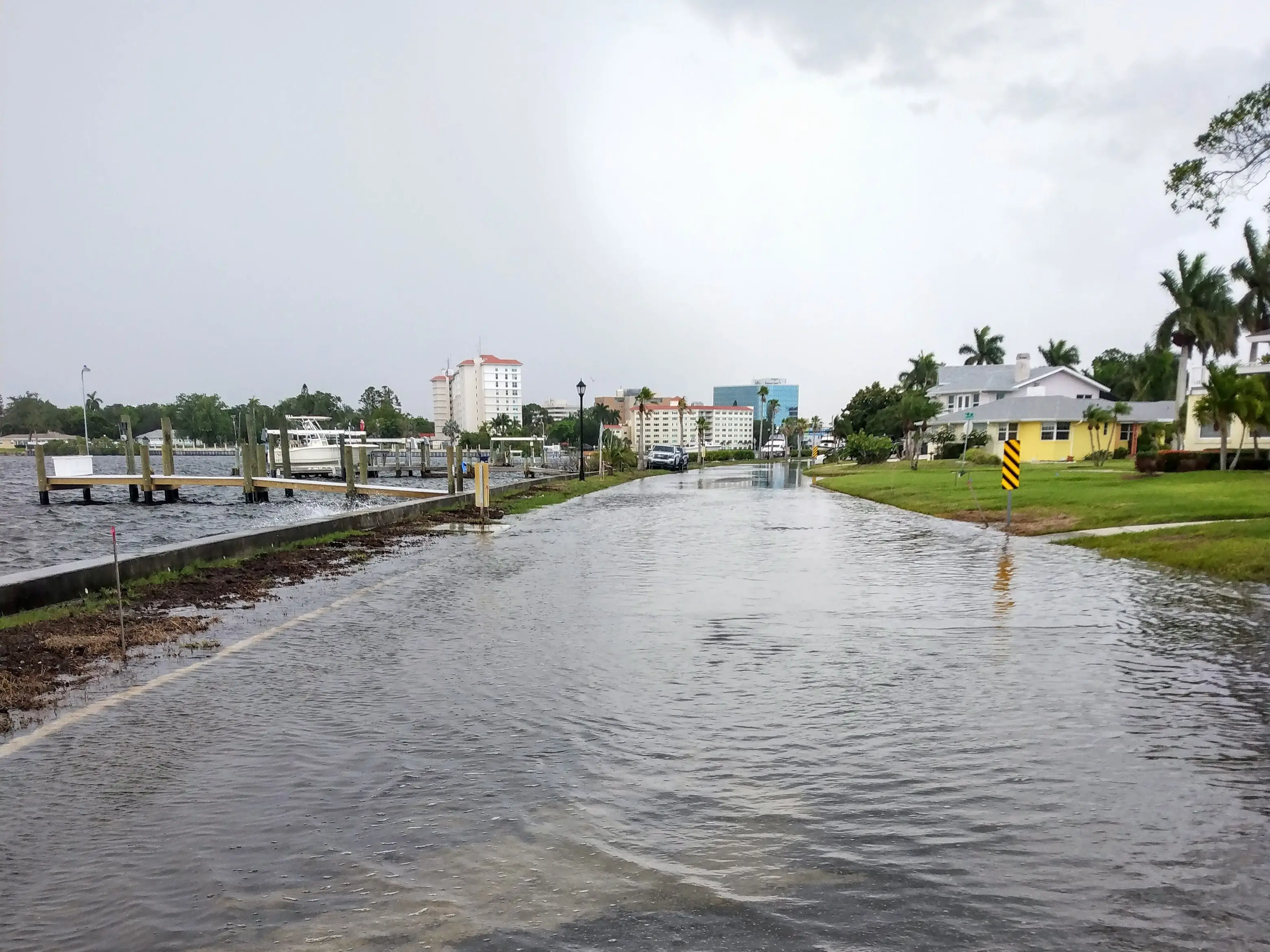 Flooded streets, with the city standing in the background.