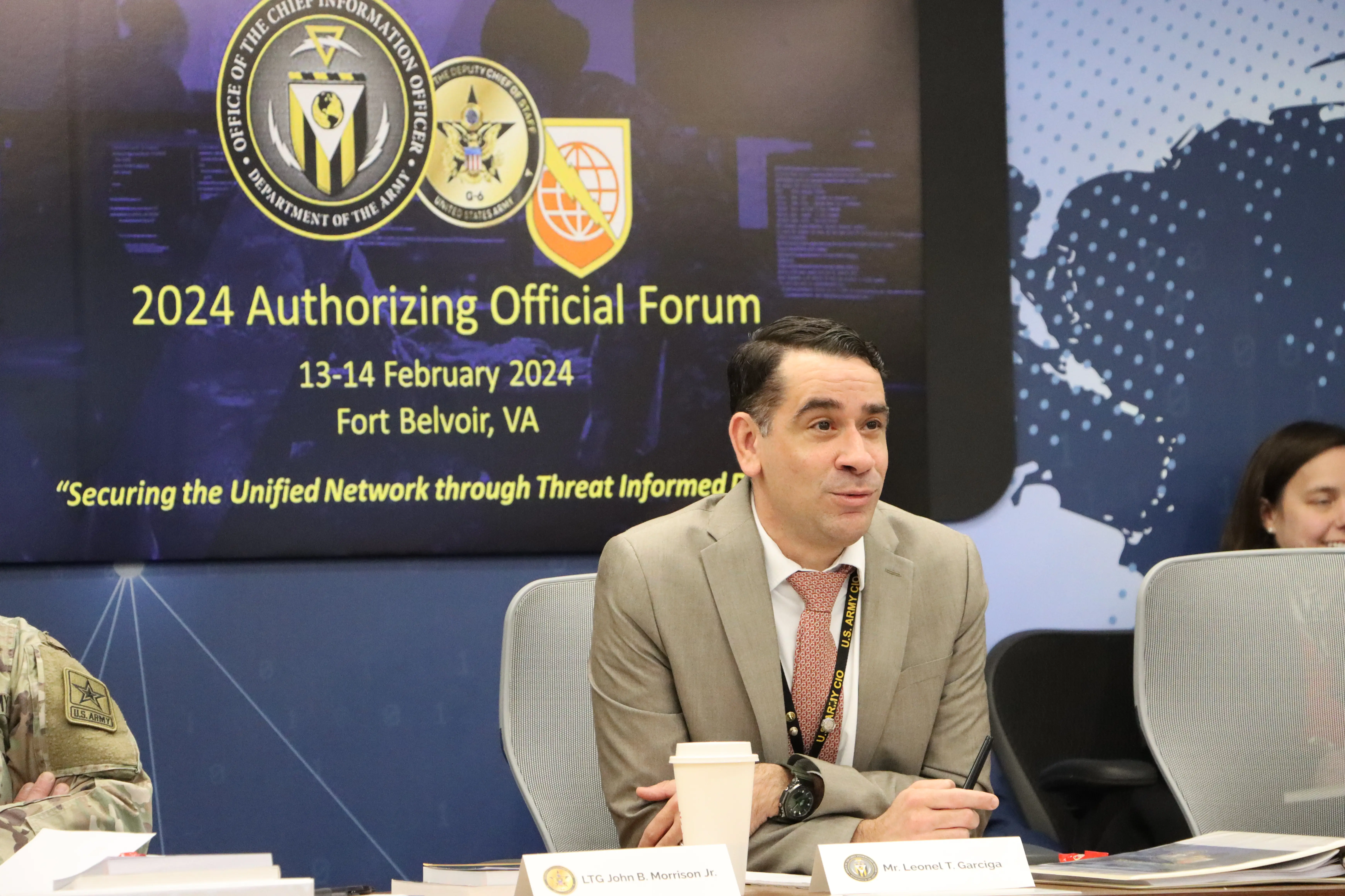 Leonel Garciga, the US Army's chief information officer, sits at a table with a beige suit.