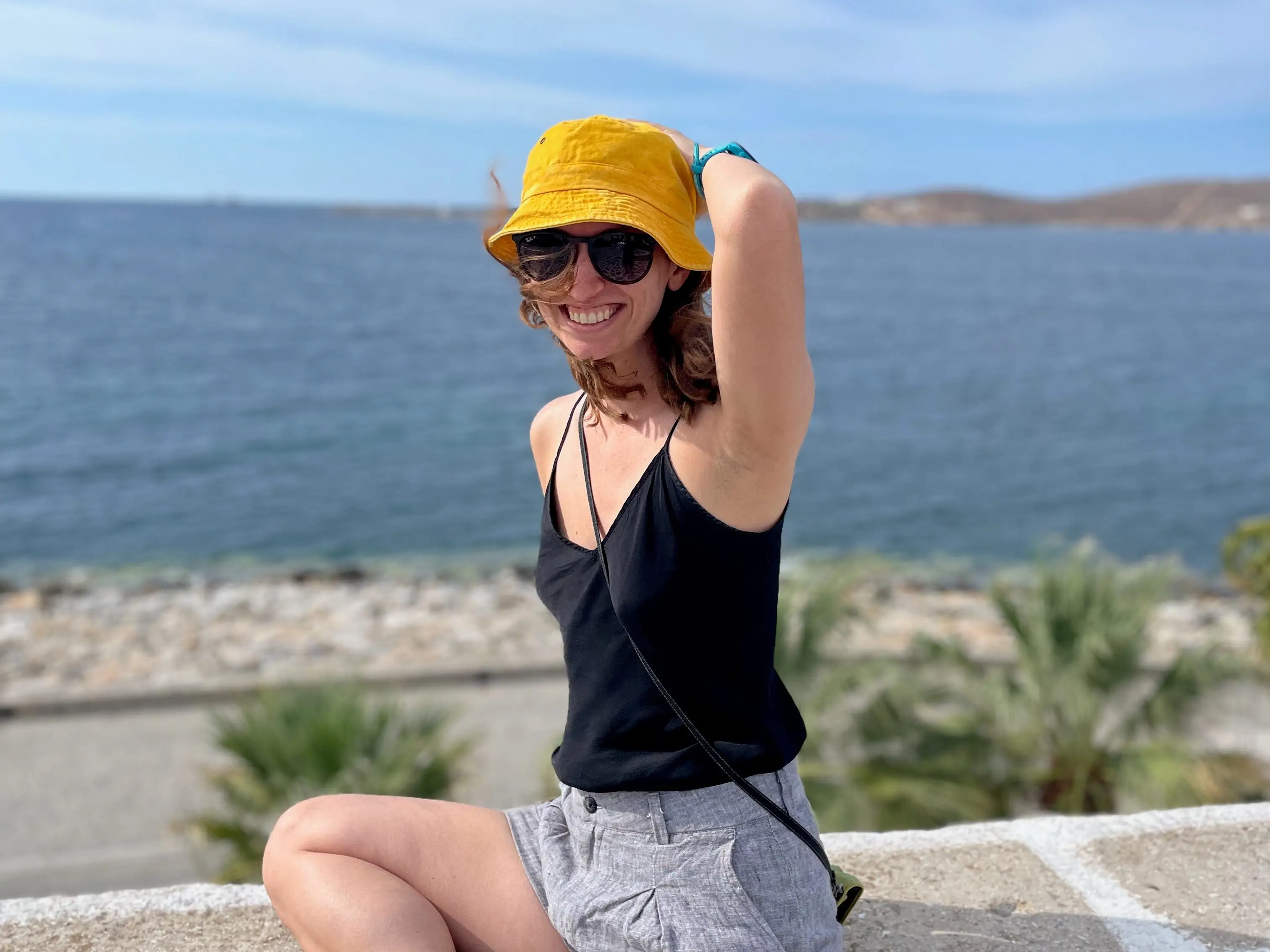 A woman wearing a yellow hat in Paros, Greece.